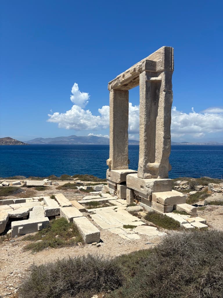 A Greek ruin with the sea behind it.