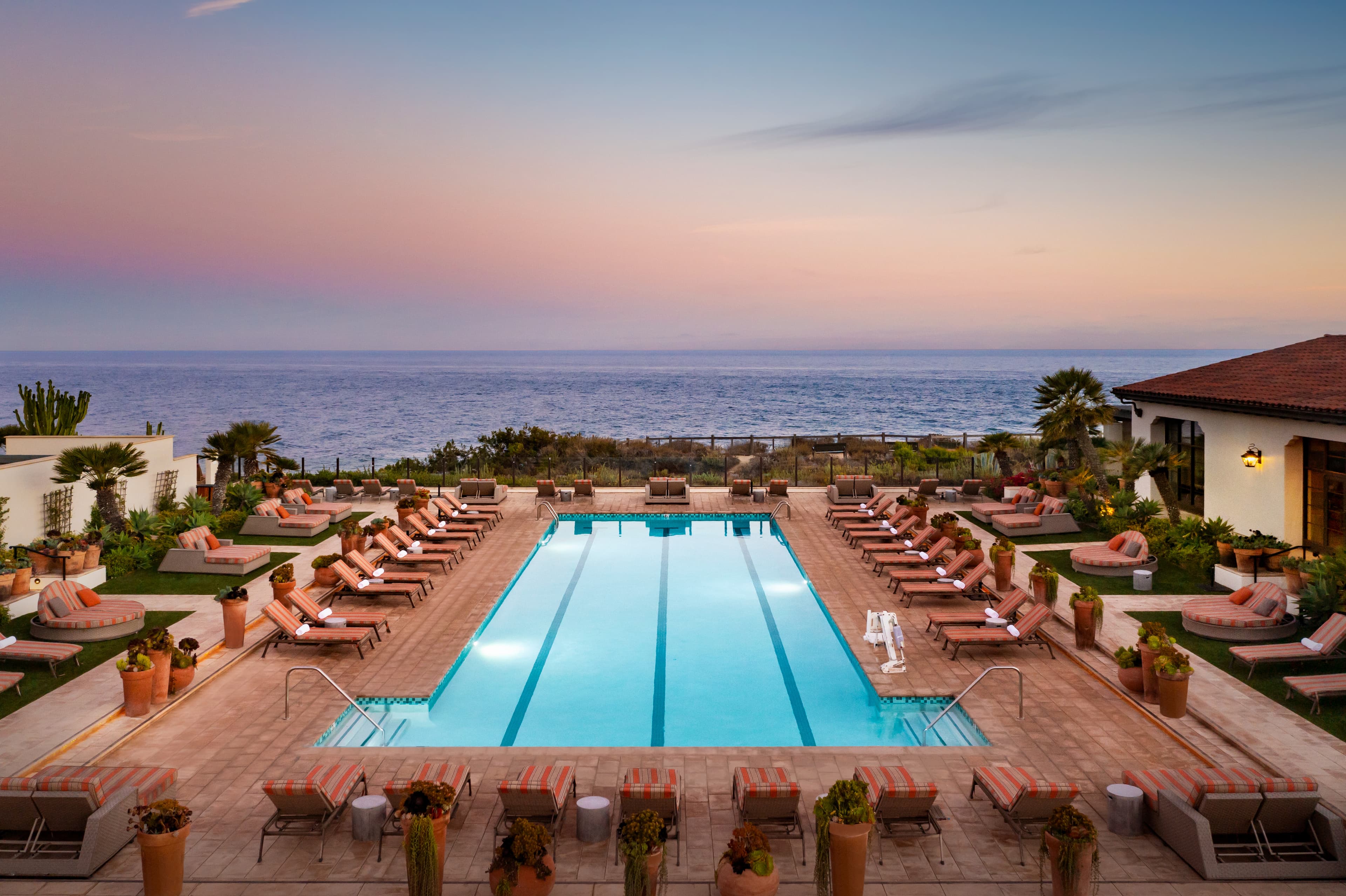 A view of the outdoor spa pool at Terranea Resort with ocean views at sunset.