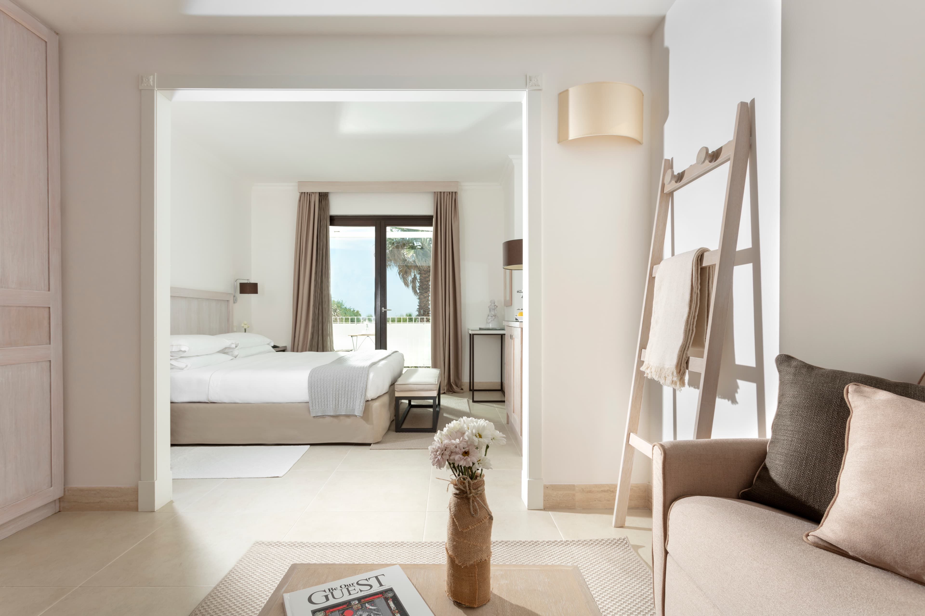 The intierior of a suite at Canne Bianche hotel in Puglia, Italy with natural beige, whine and wood tones.