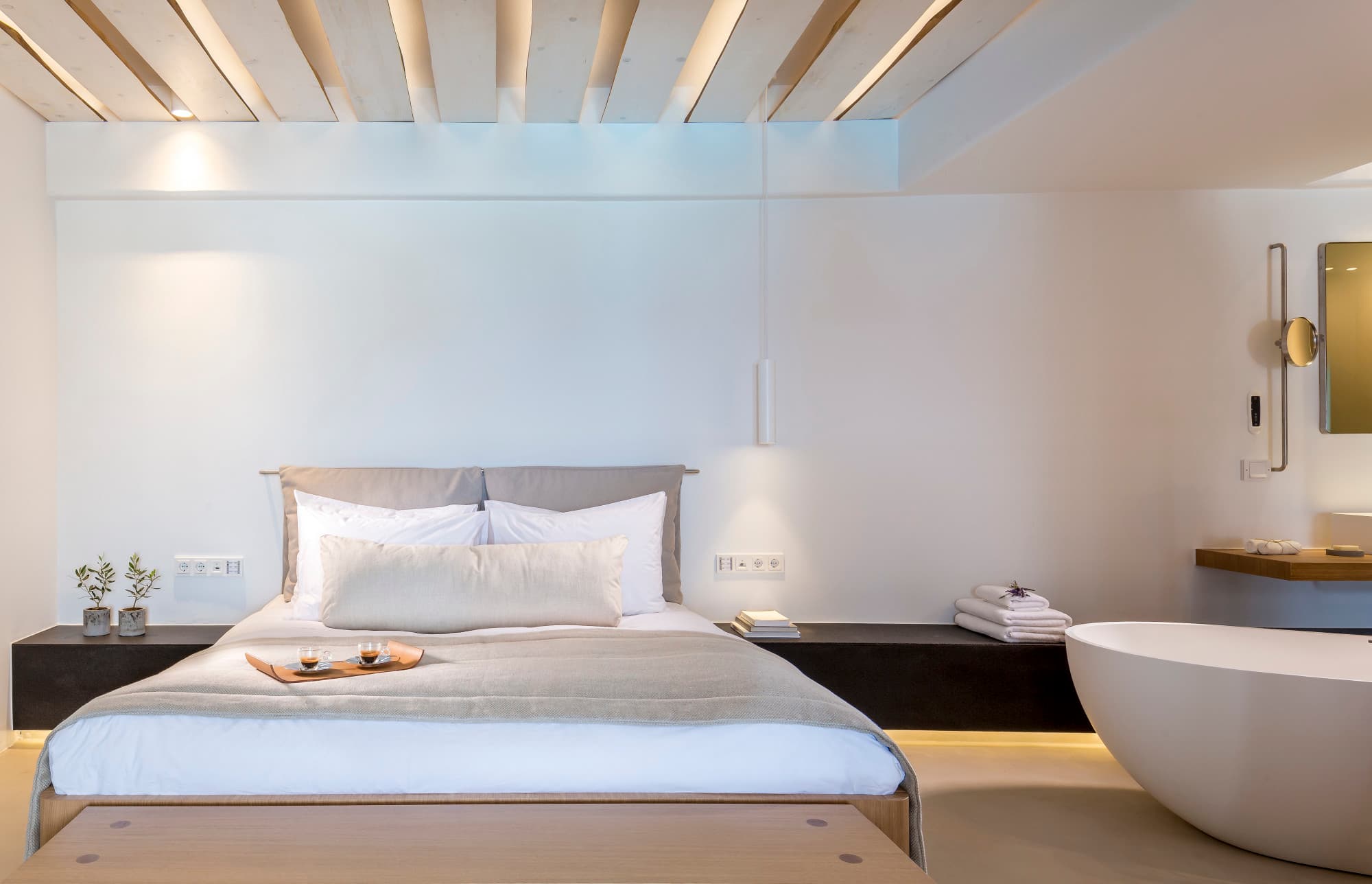 Bill & Coo suite bedroom with modern decor and stand alone bath.