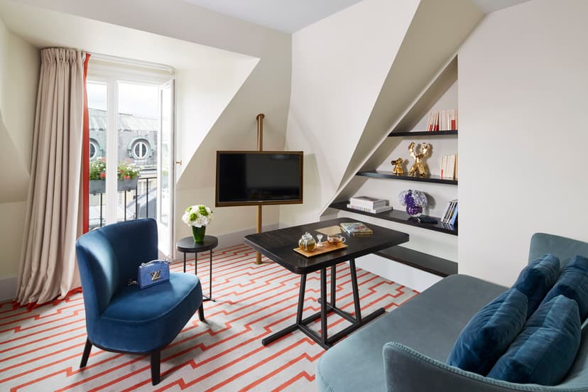 hotel suite living room with a wall with shelves filled with doodads