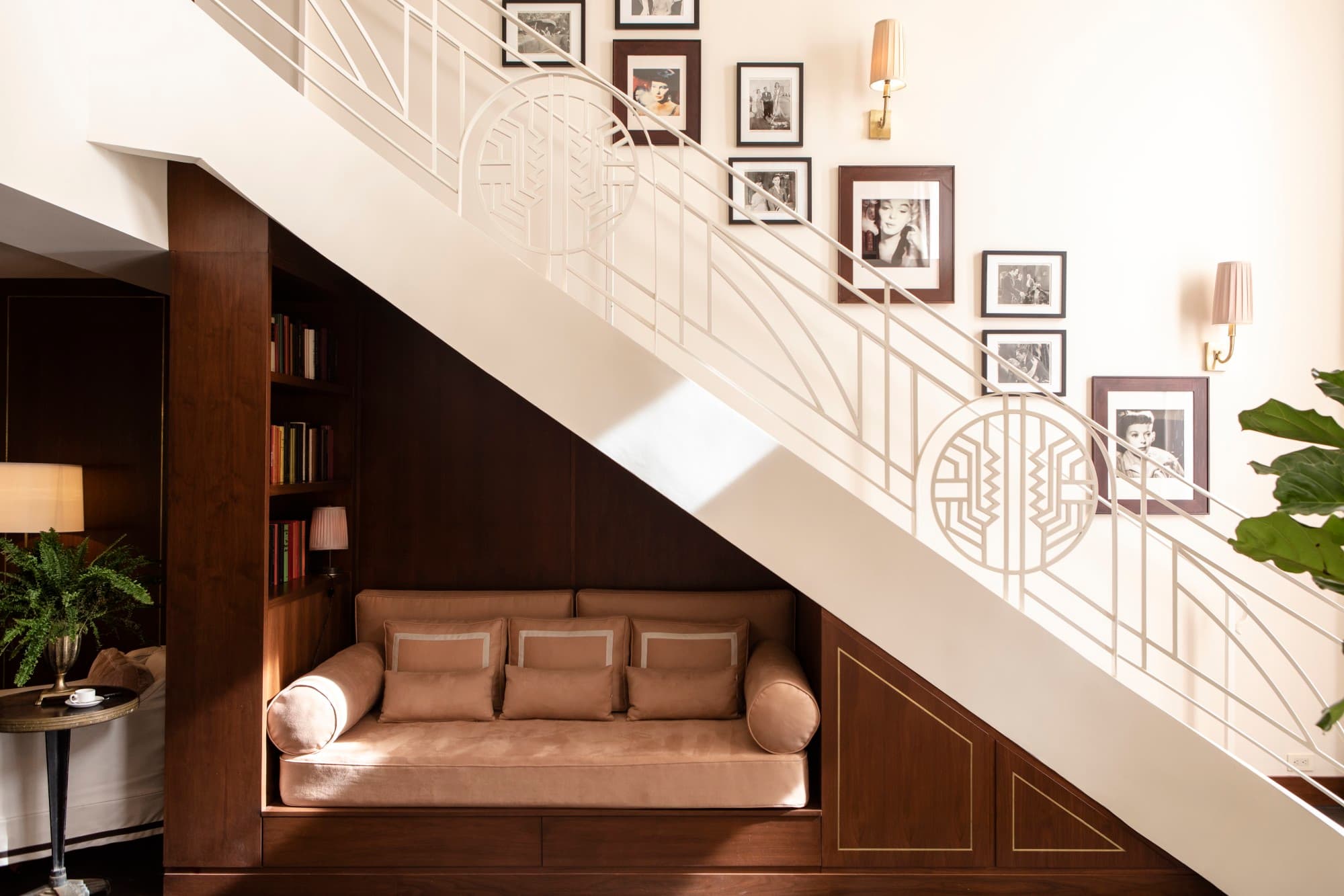 a small couch nestled underneath a staircase