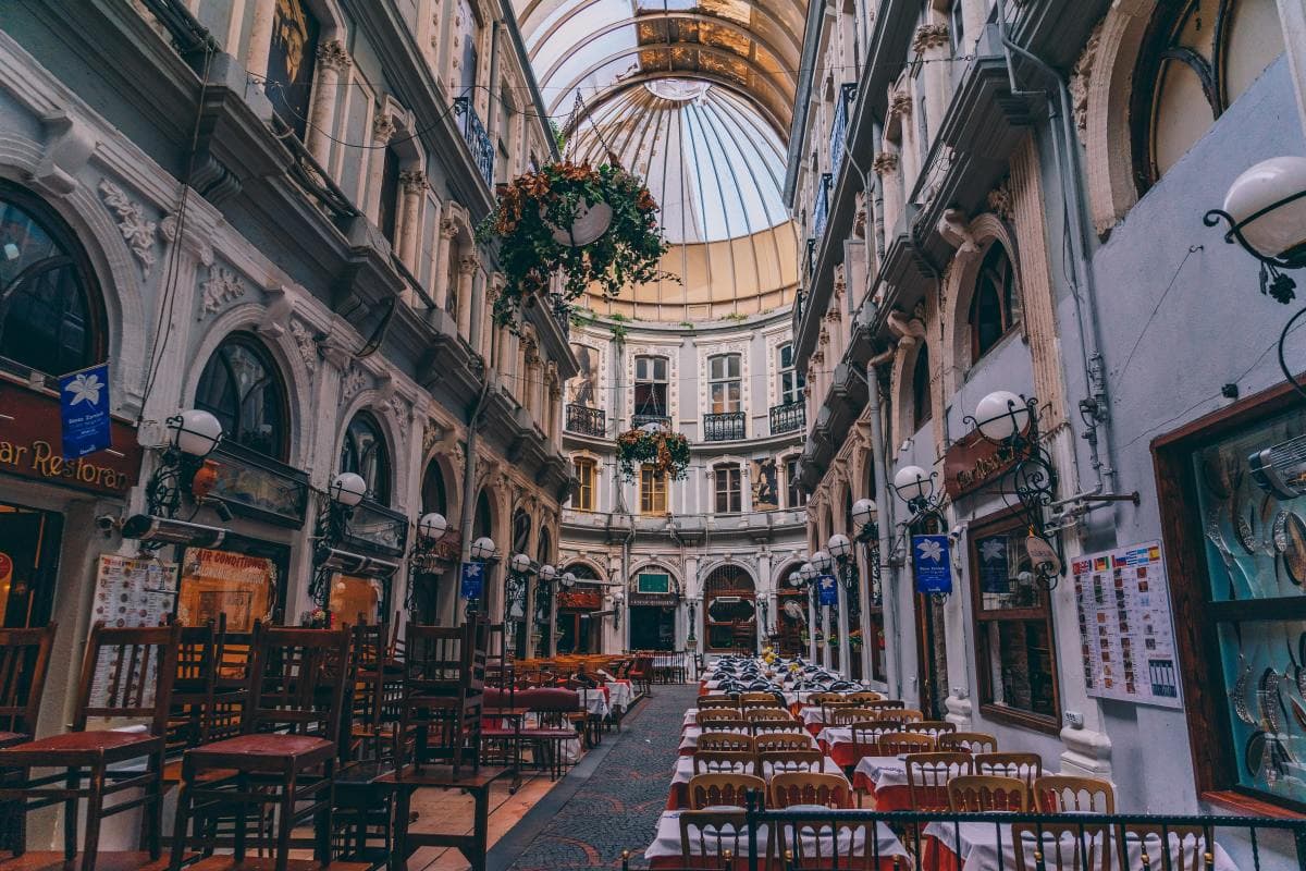 Alley plaza with cafes and restaurants amongst historical buildings.