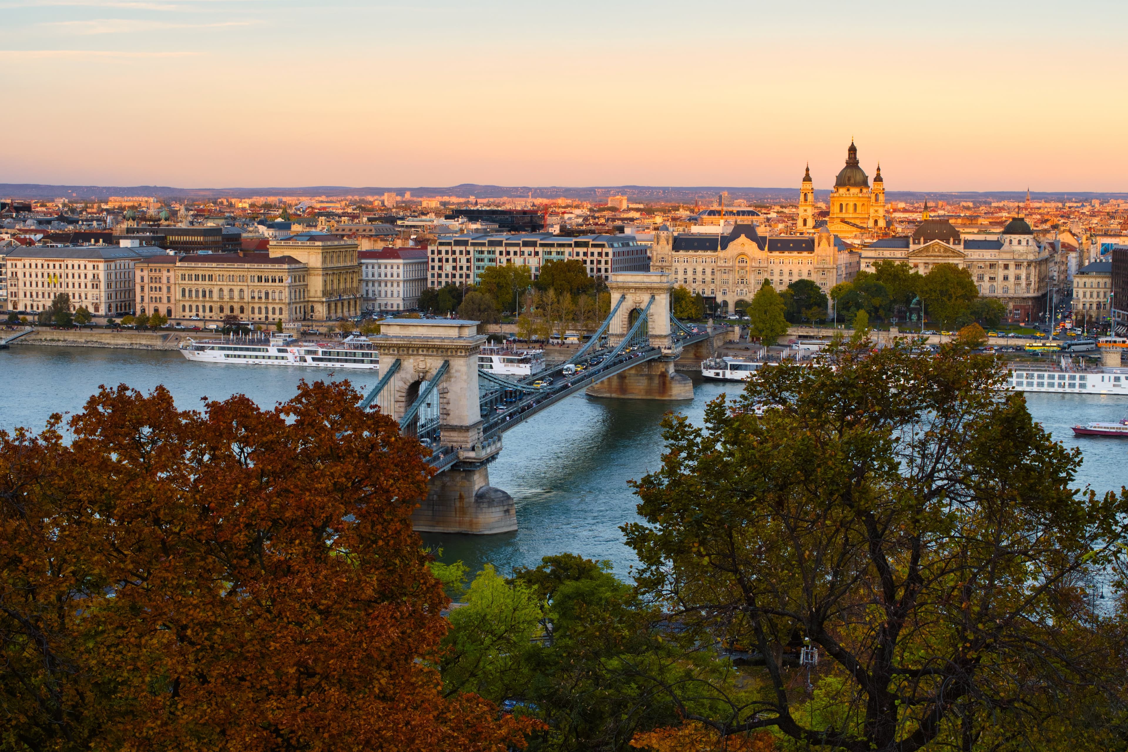 body of water with a bridge surrounded by a city