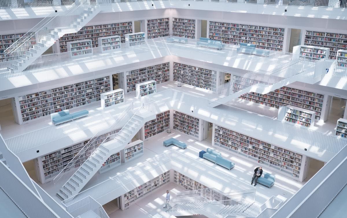 Modern all-white library with sterile design and natural light.
