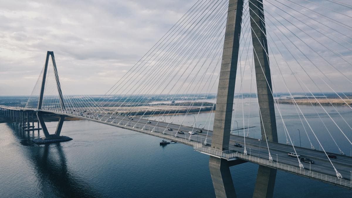 Steel bridge crossing deep blue bay in South Carolina.