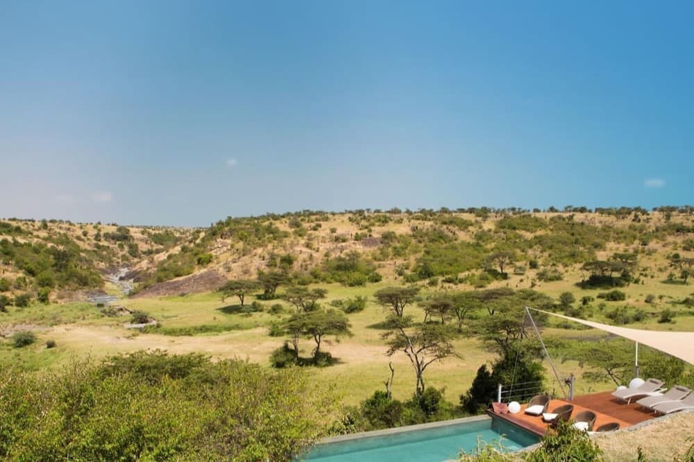 aerial view of a wooden deck with an infinity pool in the African savannah