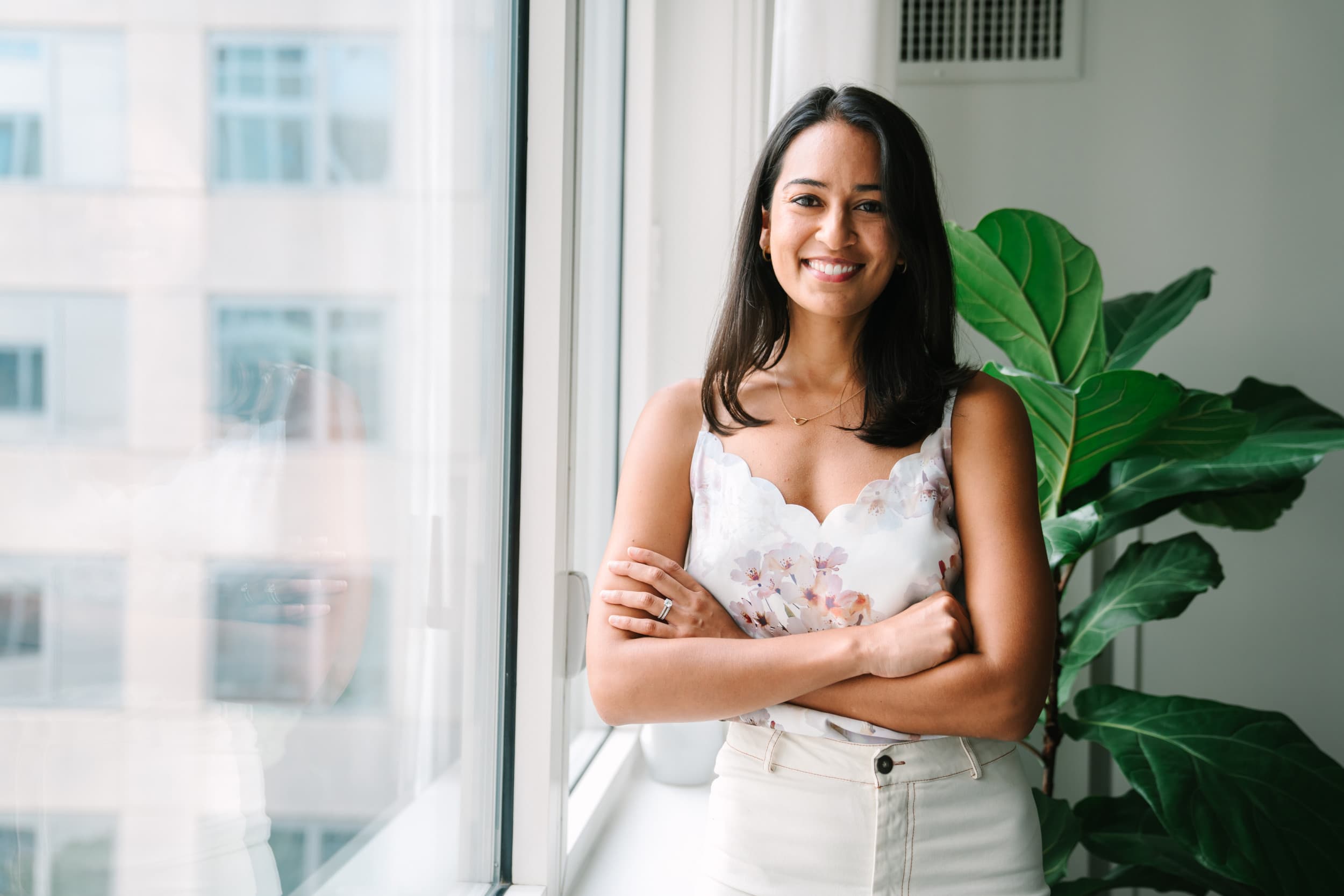 Rabia Malik, a Fora Advisor, smiles from her home in the Williamsburg neighborhood in Brooklyn, New York.