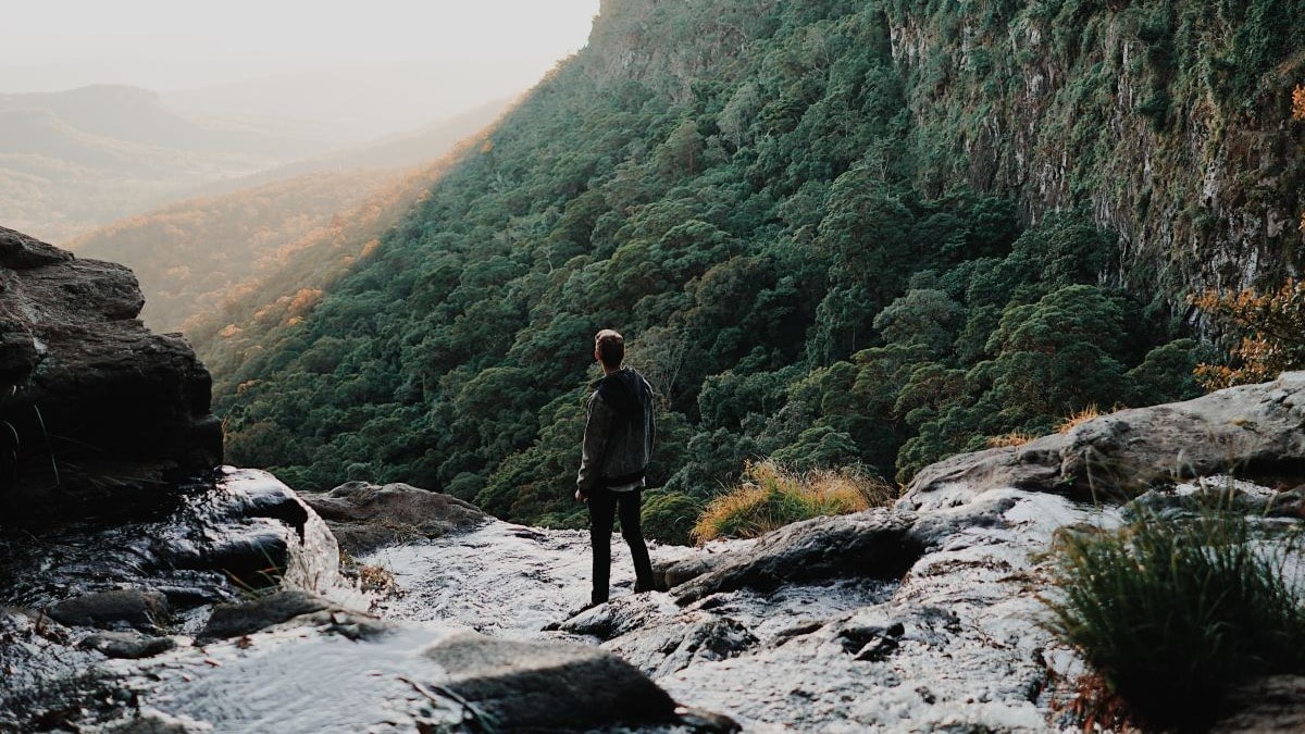 a view of a waterfall and mountains