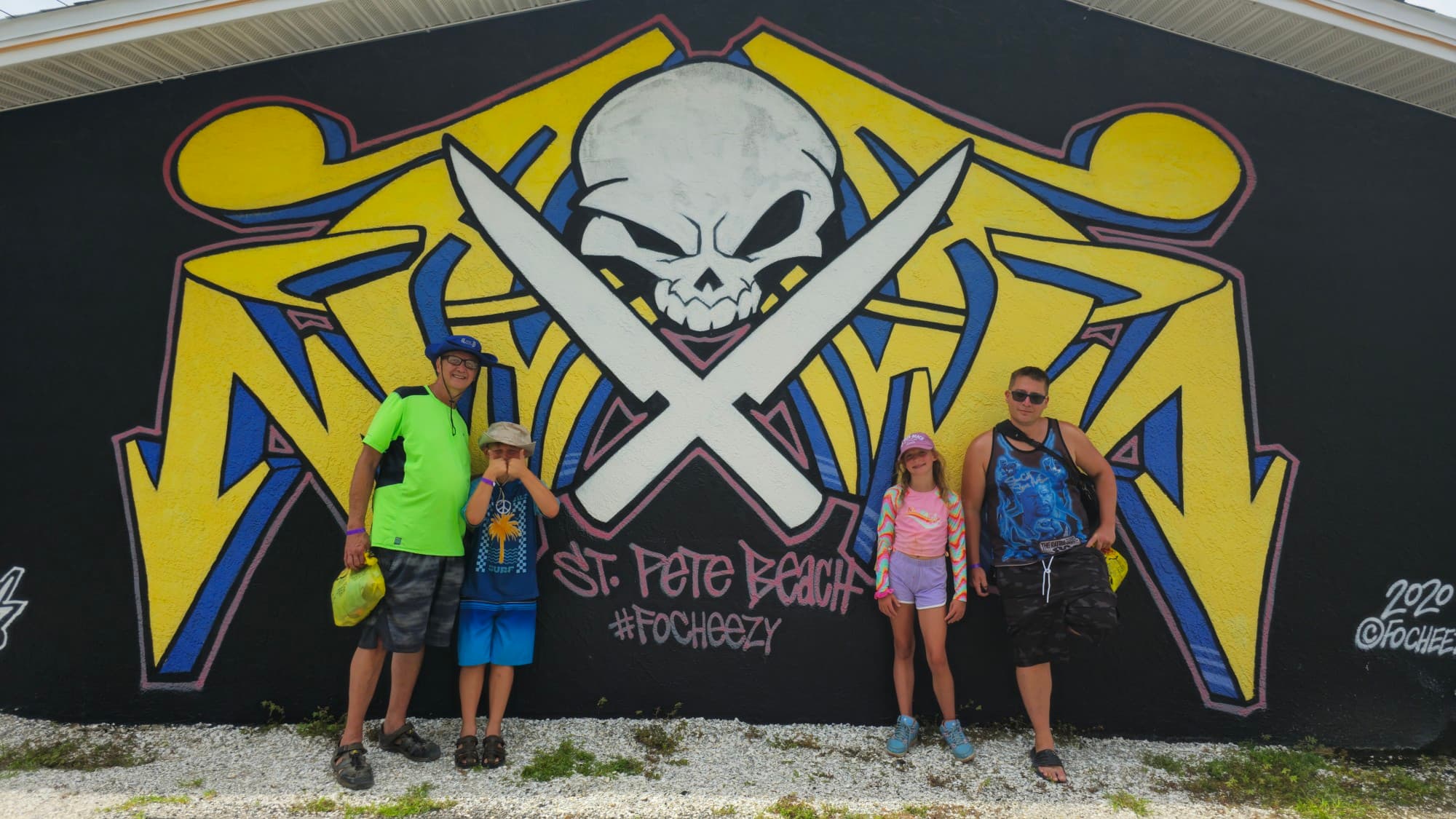 Men posing with kids with an art backdrop
