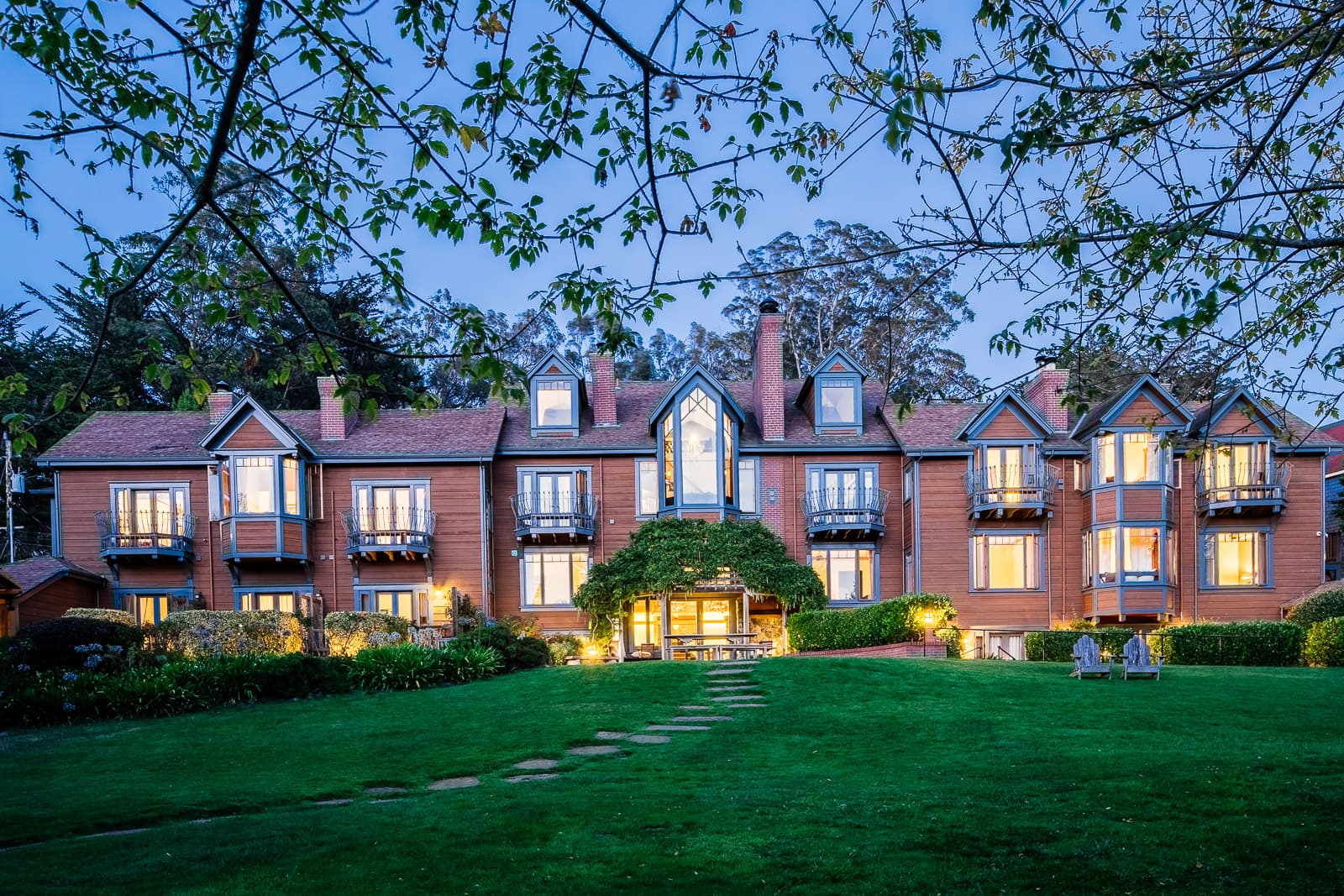 The exterior of a large house lit up at nighttime