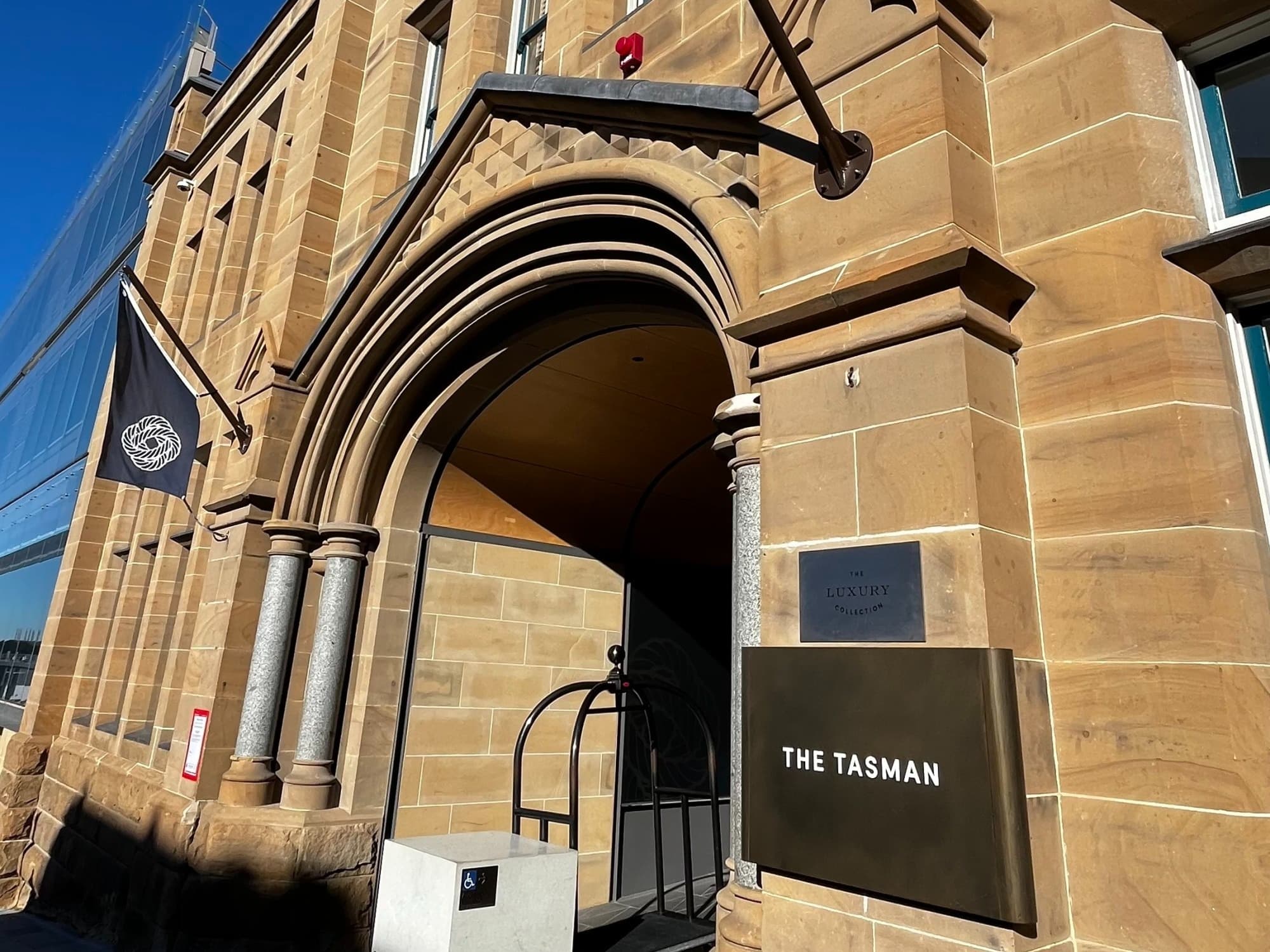 Facade of The Tasman Hotel on a sunny day.