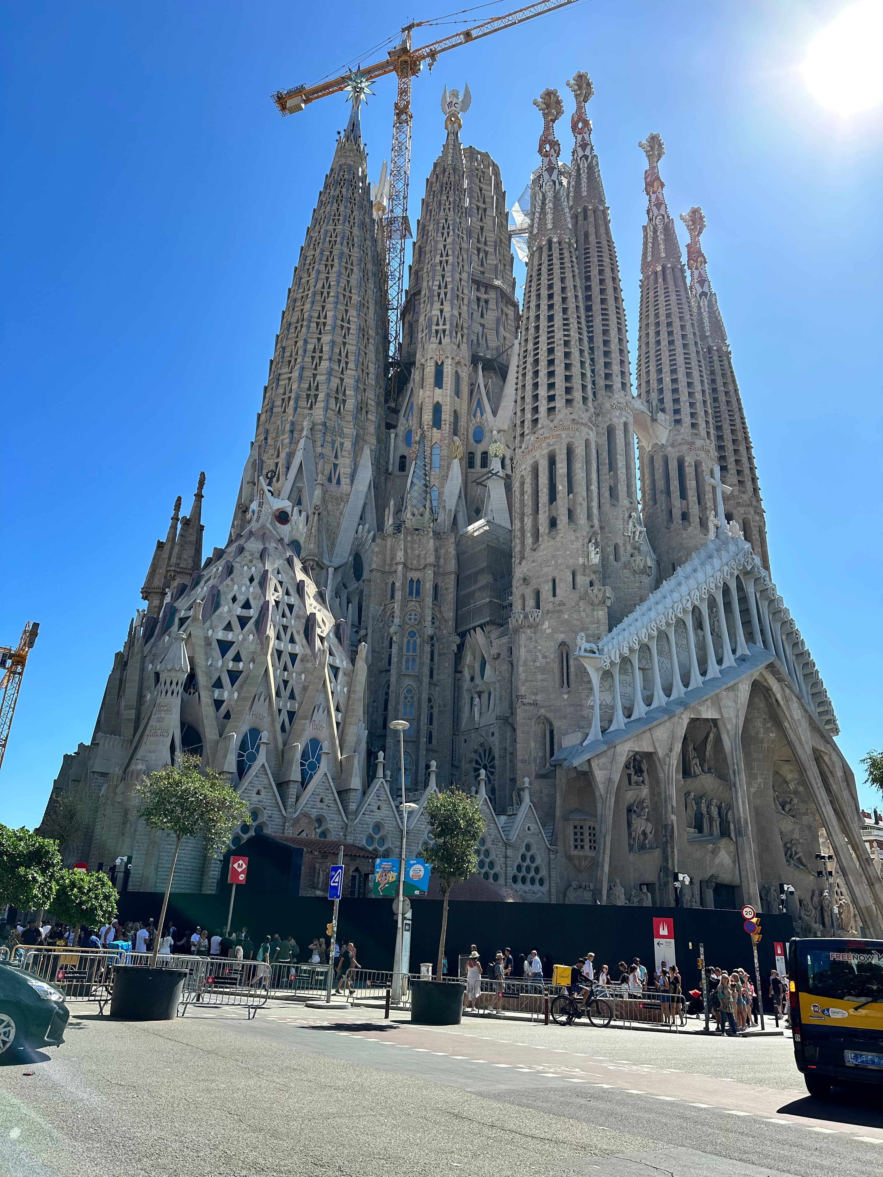 A low-angled view of a tall cathedral in a city street