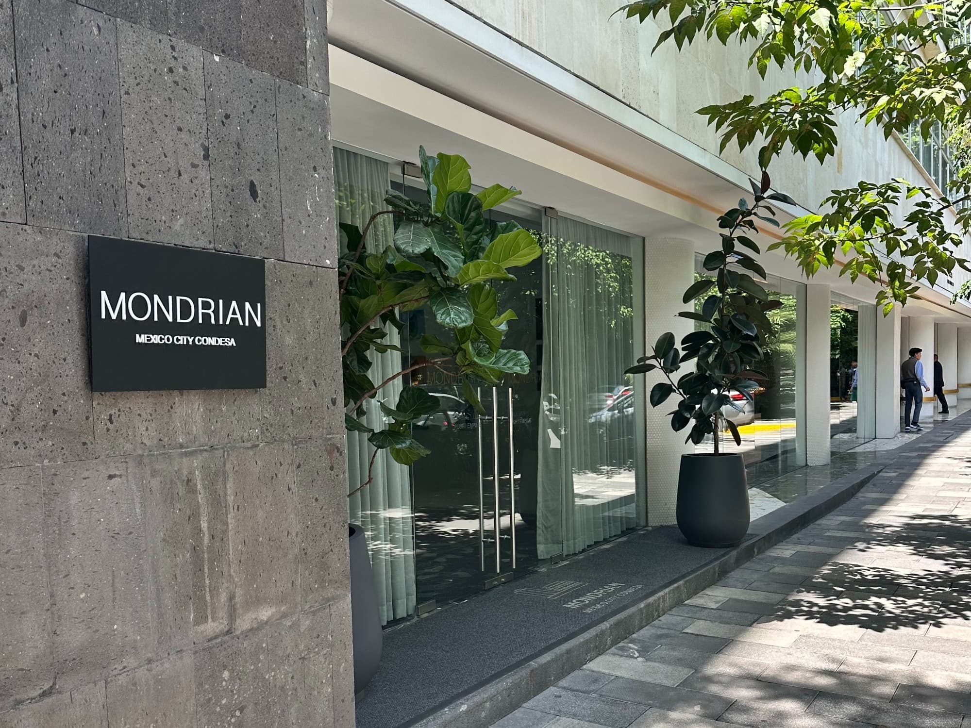 Mondrian hotel entrance on a tree-lined street on a sunny day