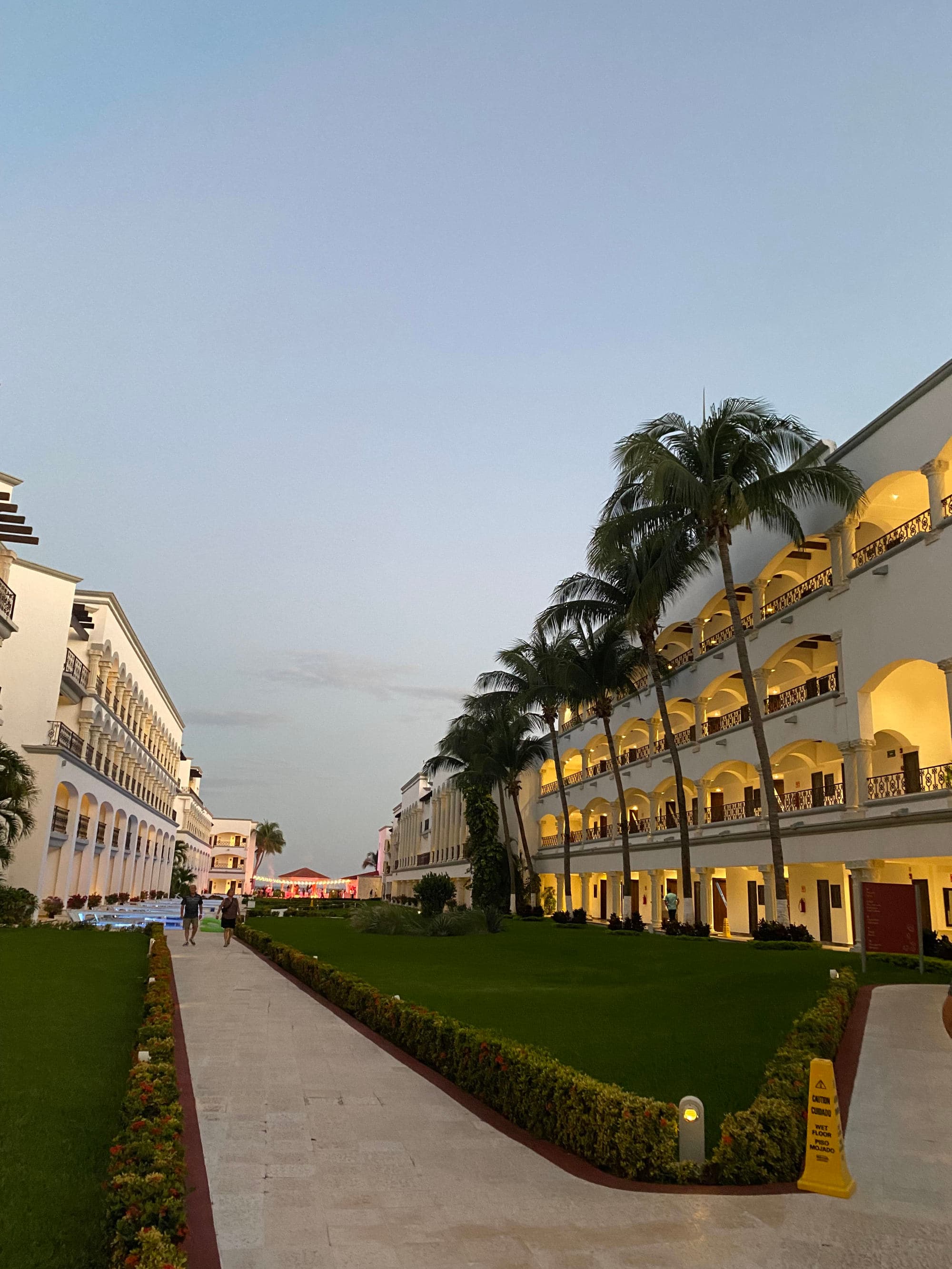 An outside courtyard of a resort during the evening