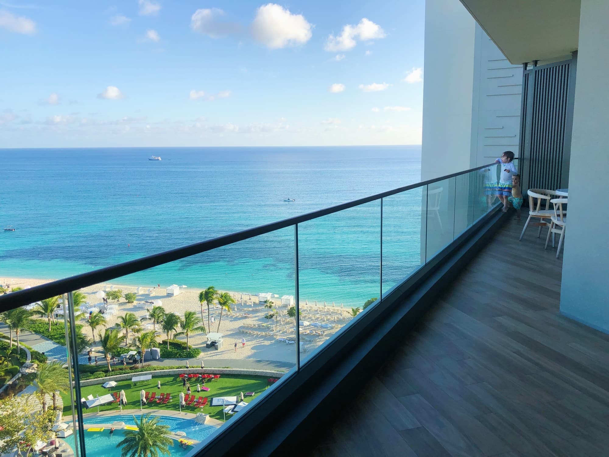 Balancony with a glass railing and an ocean view.