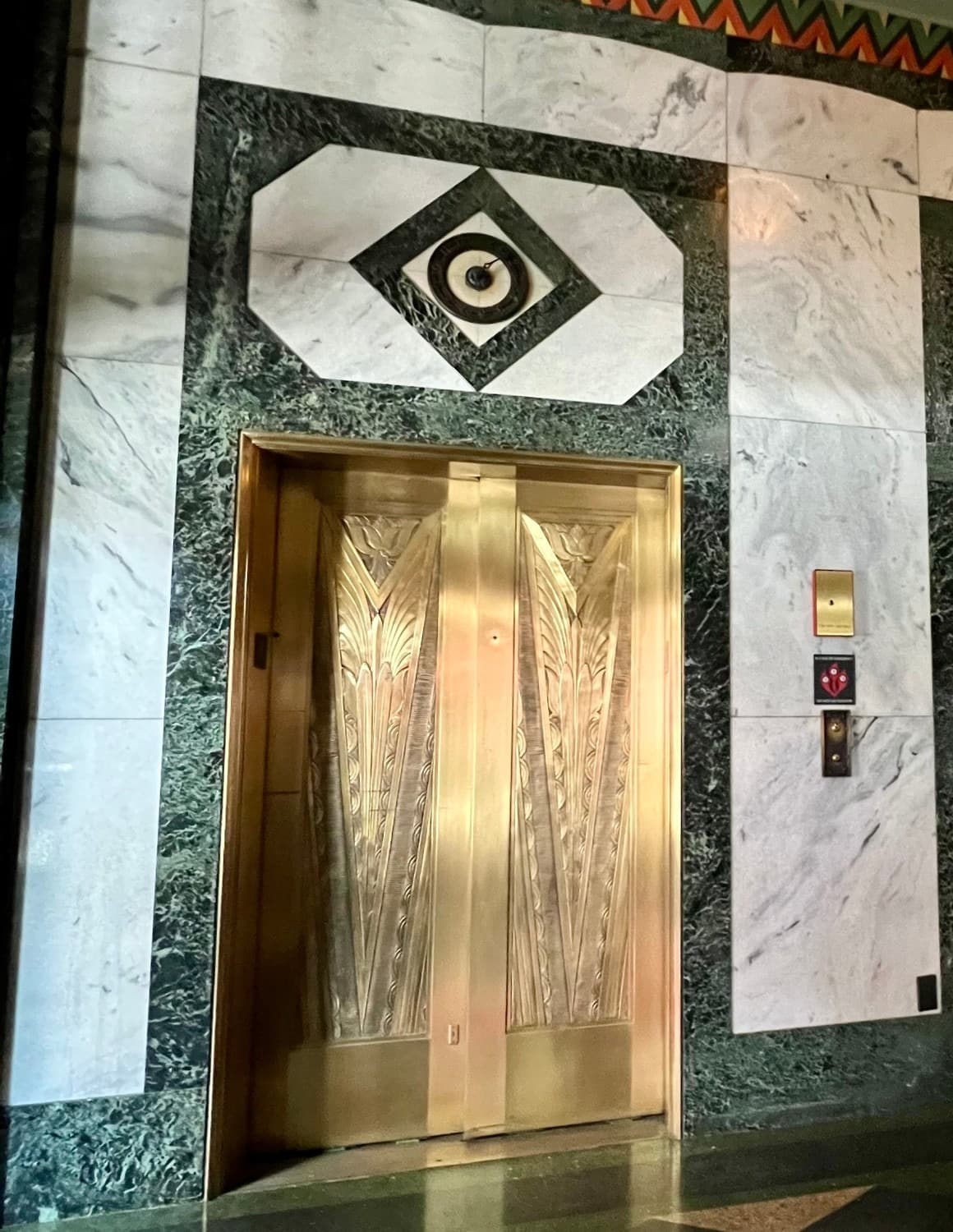 Art deco elevators in the lobby of a hotel.