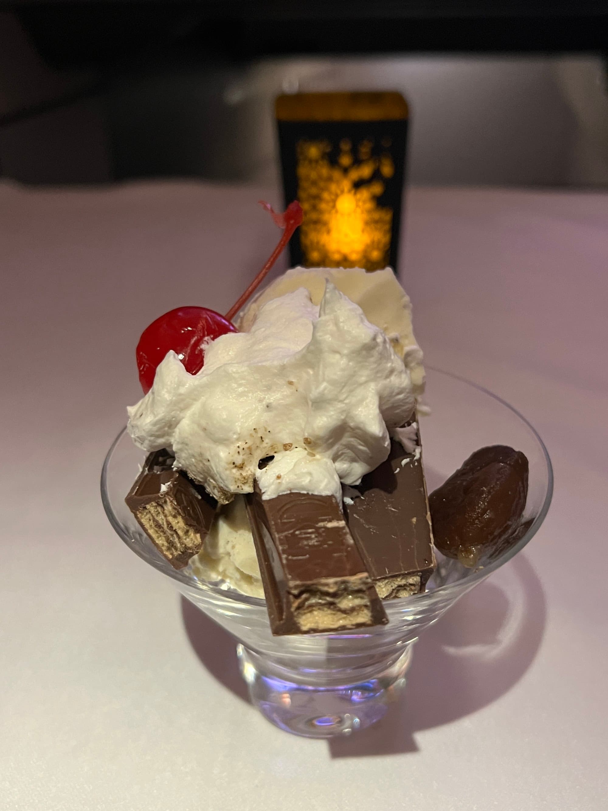 Mont Blanc sundae with chocolate , whip cream and a cherry on top.