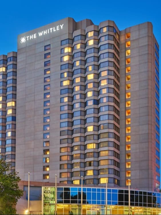 A tall hotel skyscraper that says The Whitley at the top.
