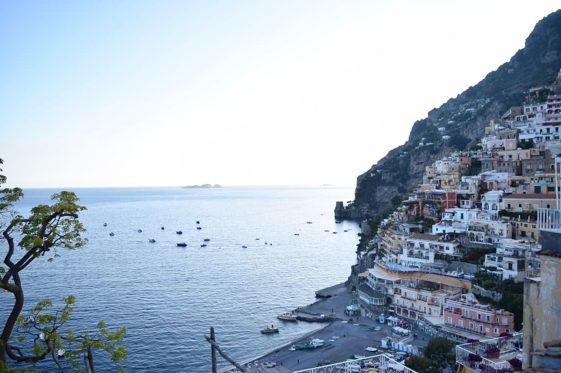 Colorful buildings on the side of a hill next to the sea