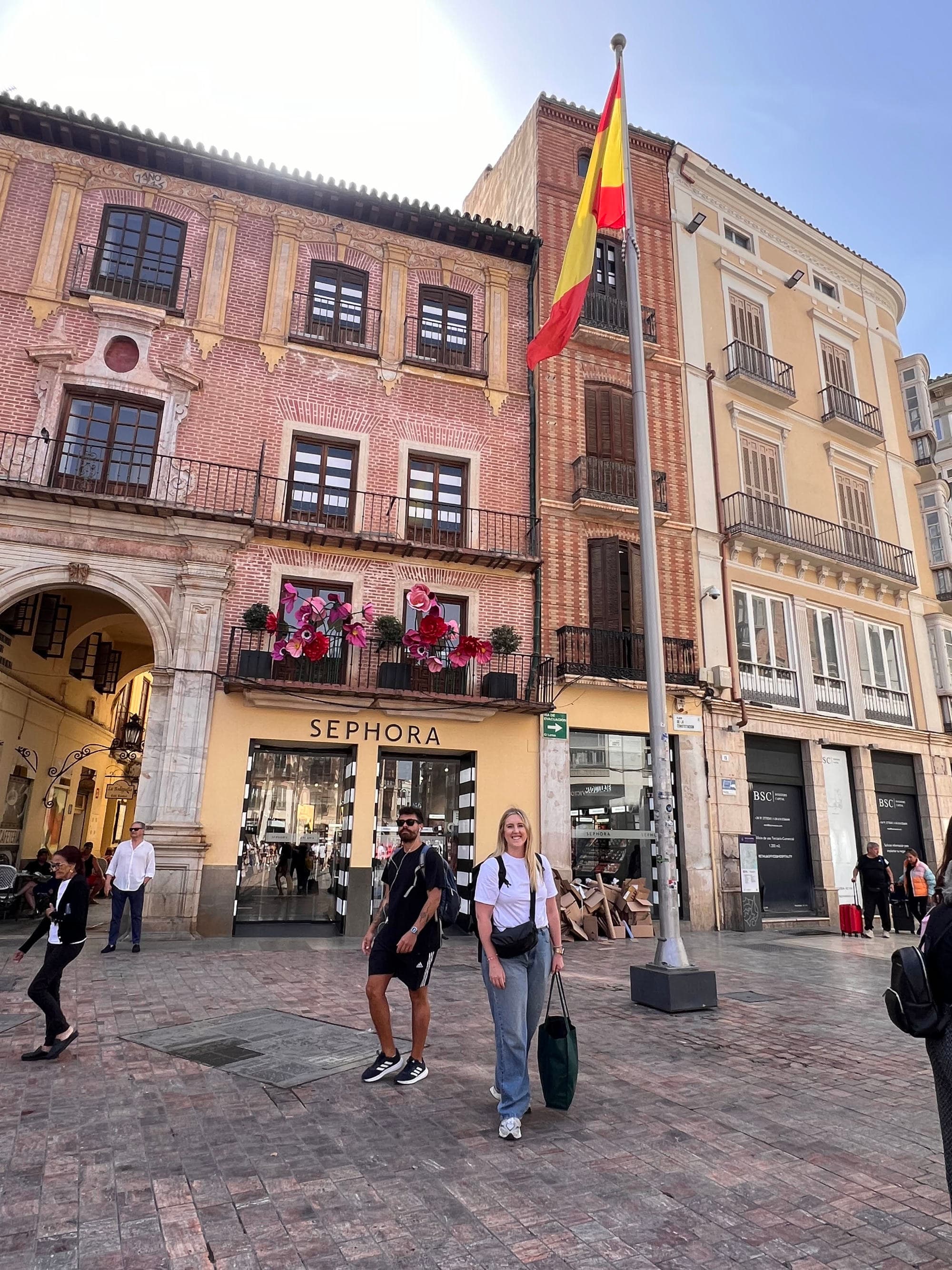 Travel advisor posing outside a building on a city street