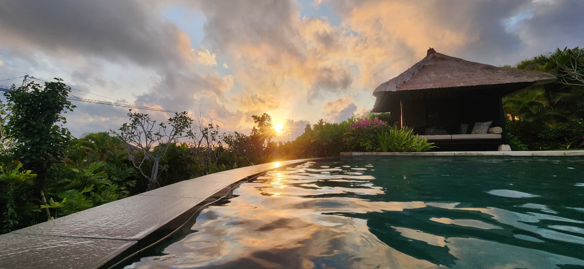 A sunrise over a swimming pool