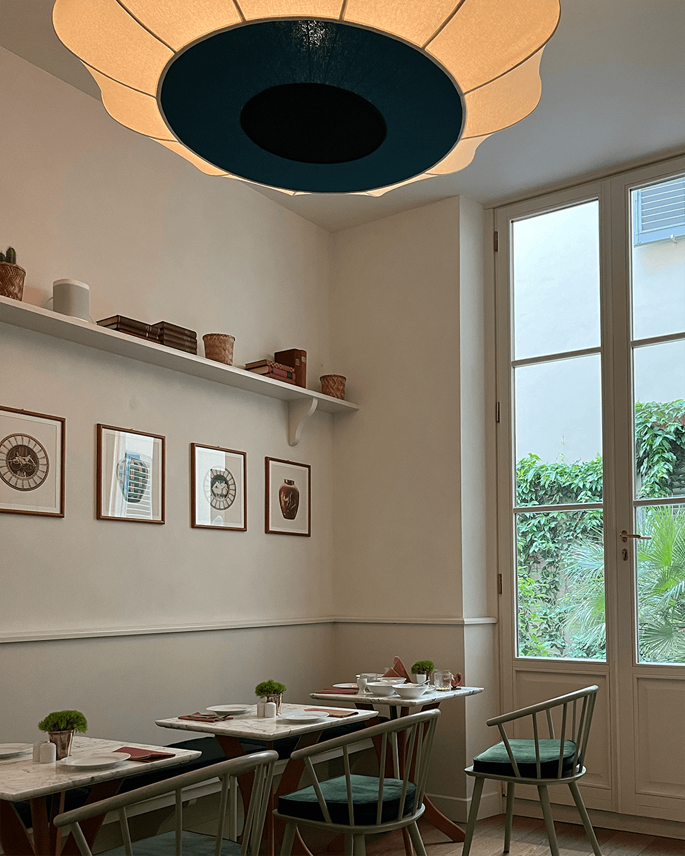 A dining area with small tables in a white room