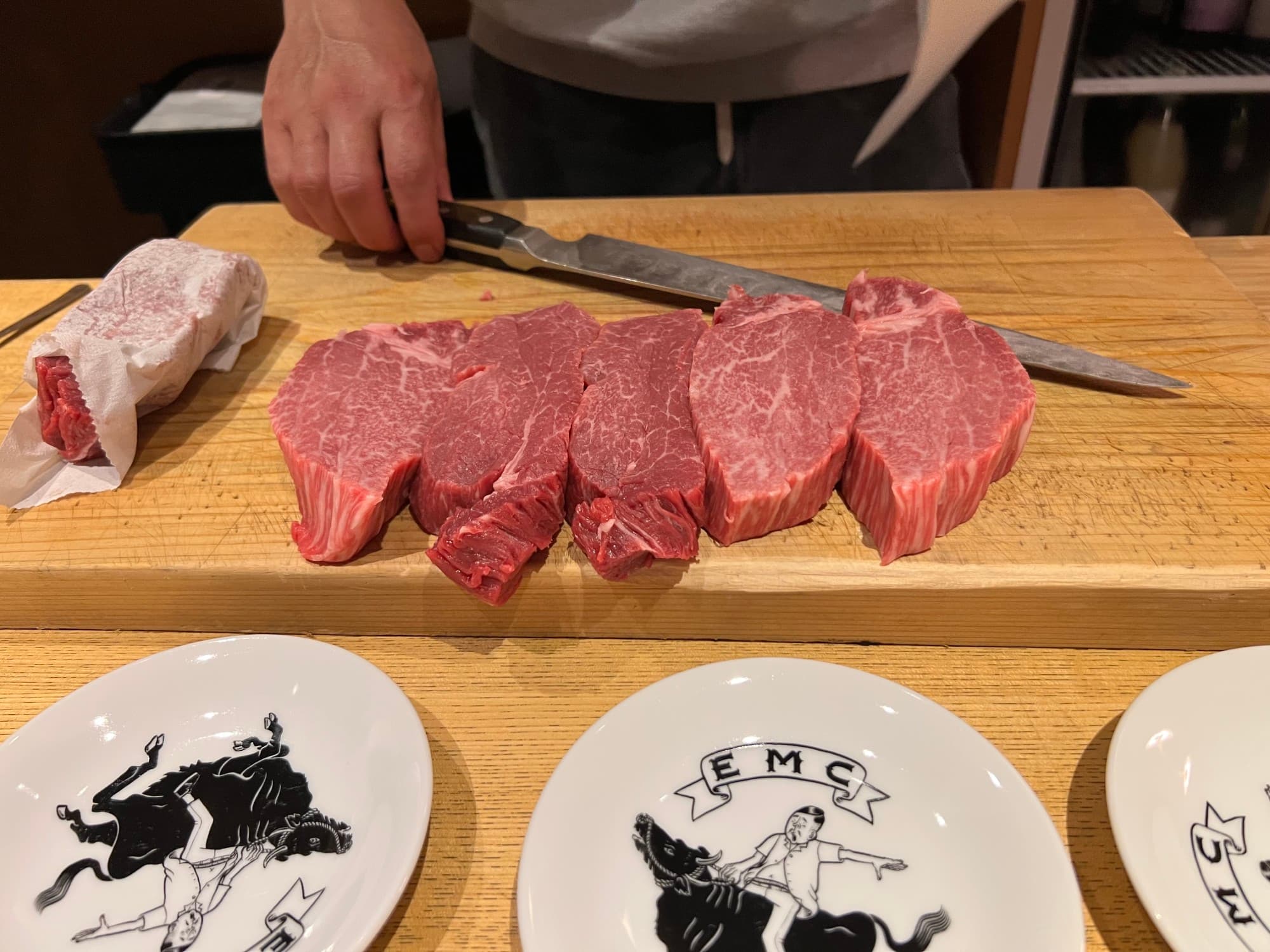 Raw beef slices on a wooden cutting board