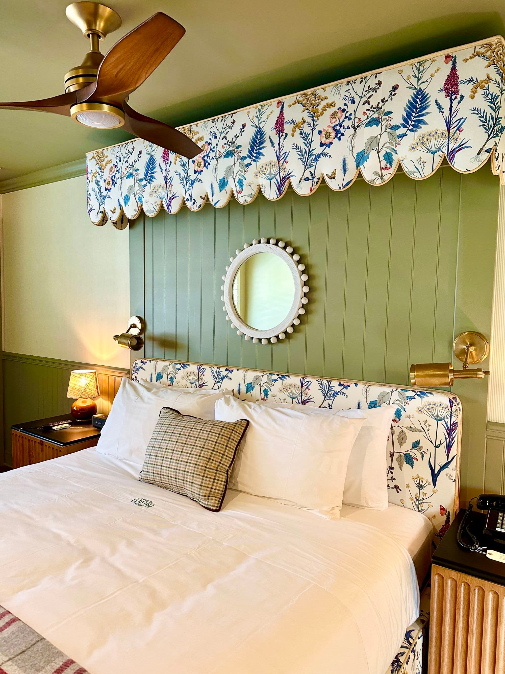 Le Petit Pali King Room - a white bed with a blue-and-white headboard, green walls, and a wooden fan above