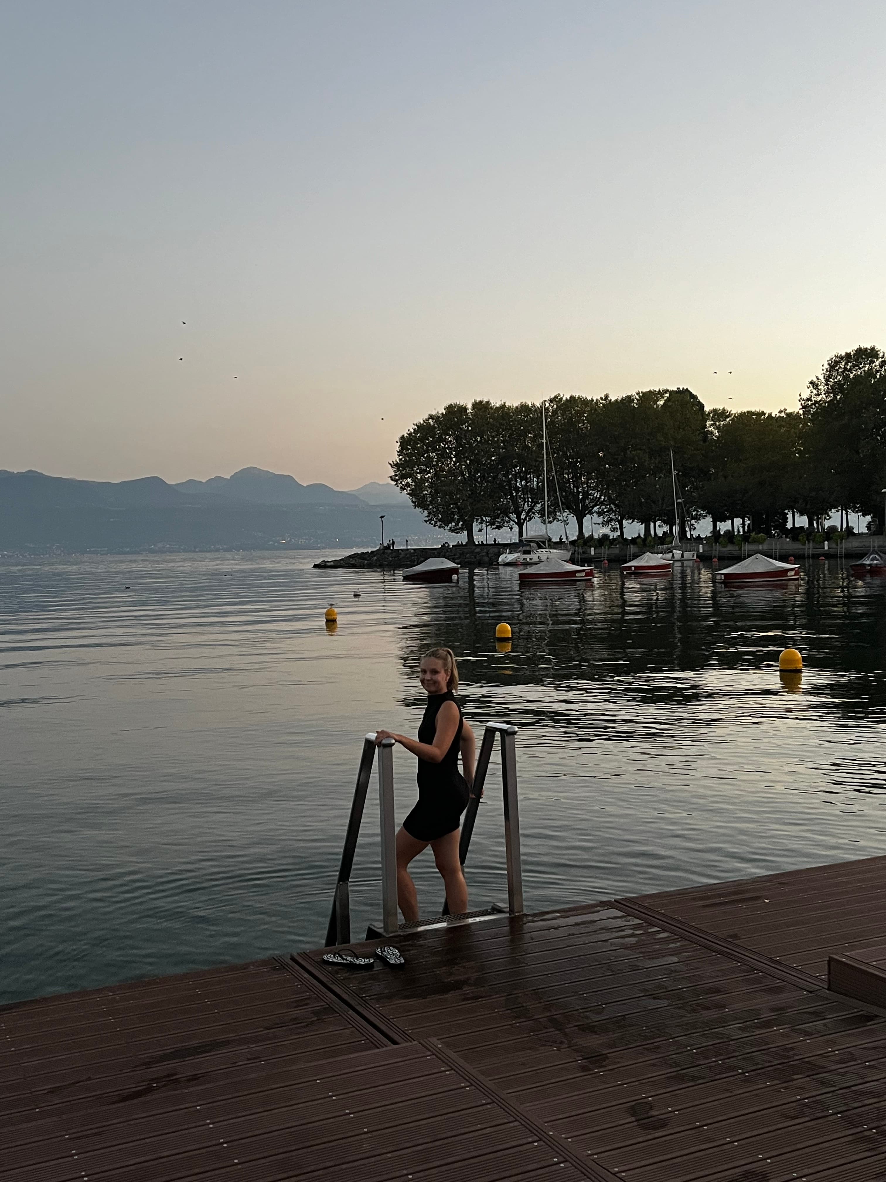 Chateau D'Ouchy boat dock view at sunset with Katherine Hanna heading into the water.