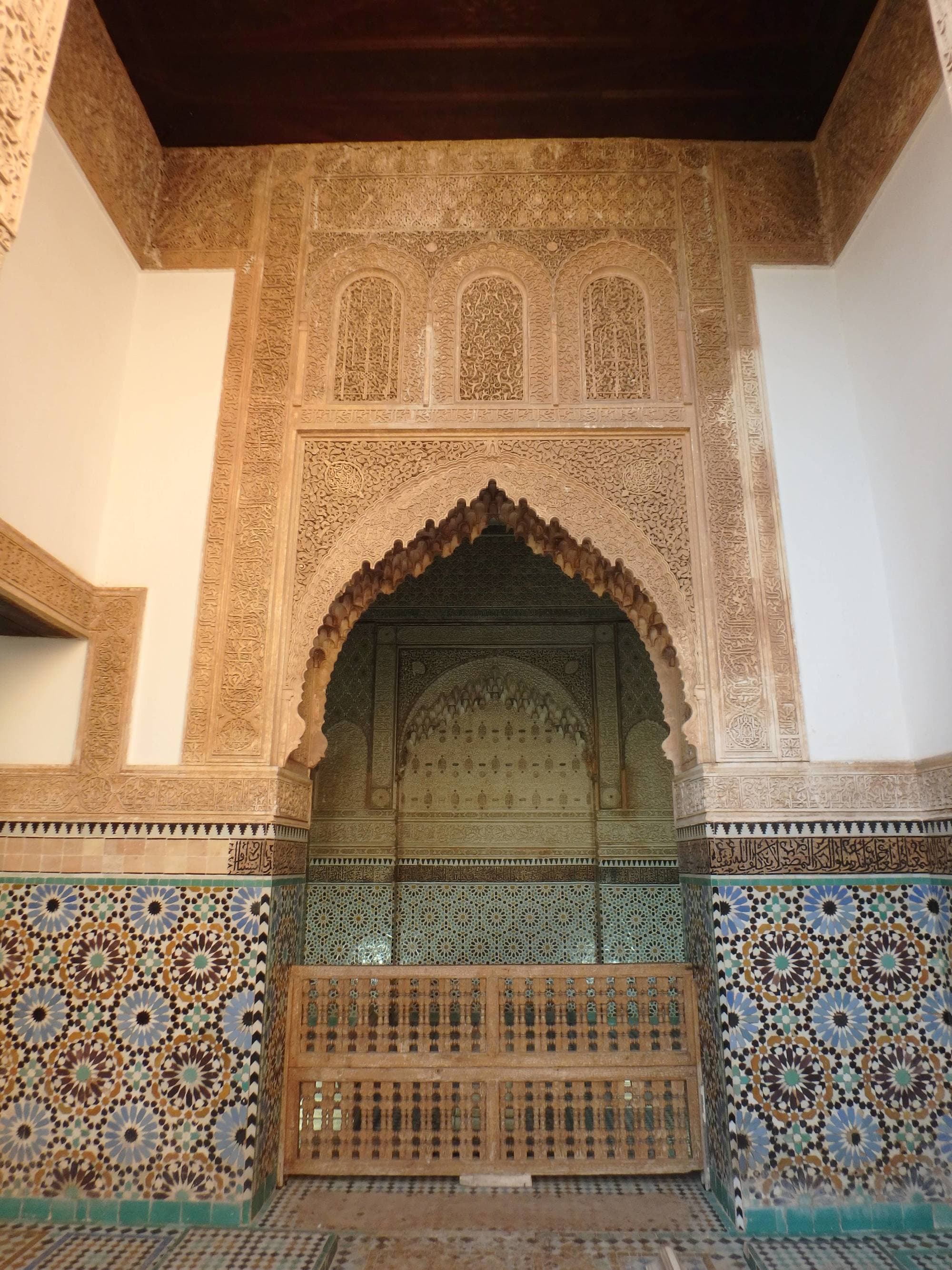 A tall, arched doorway with blue and brown tiles