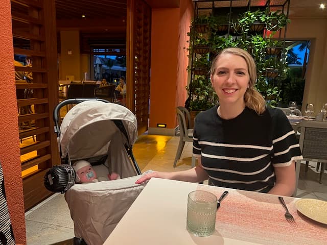 Travel advisor posing with a baby in a restaurant