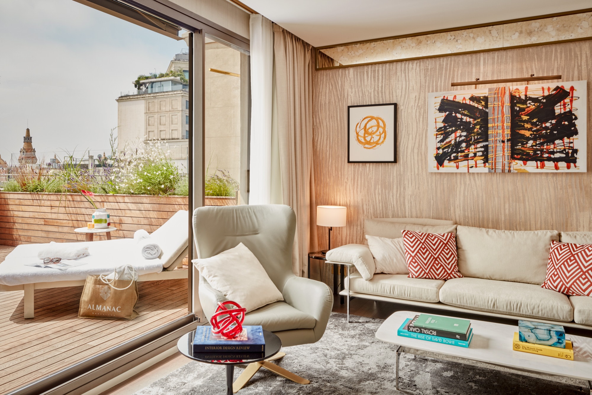 a fancy hotel suite with modern furniture and a chic outdoor terrace