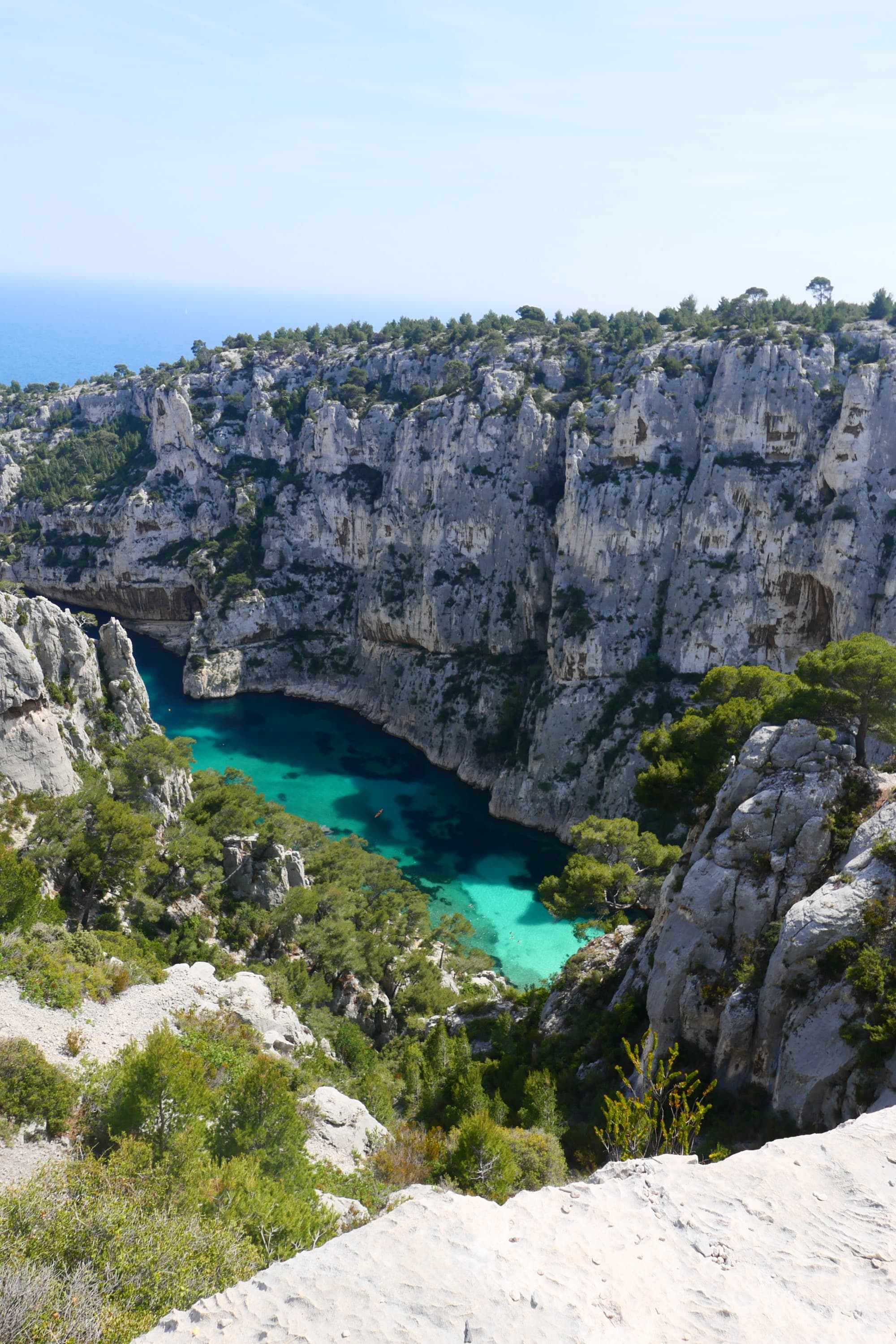 aerial view of a turquoise ocean lagoon between two rocky cliffs