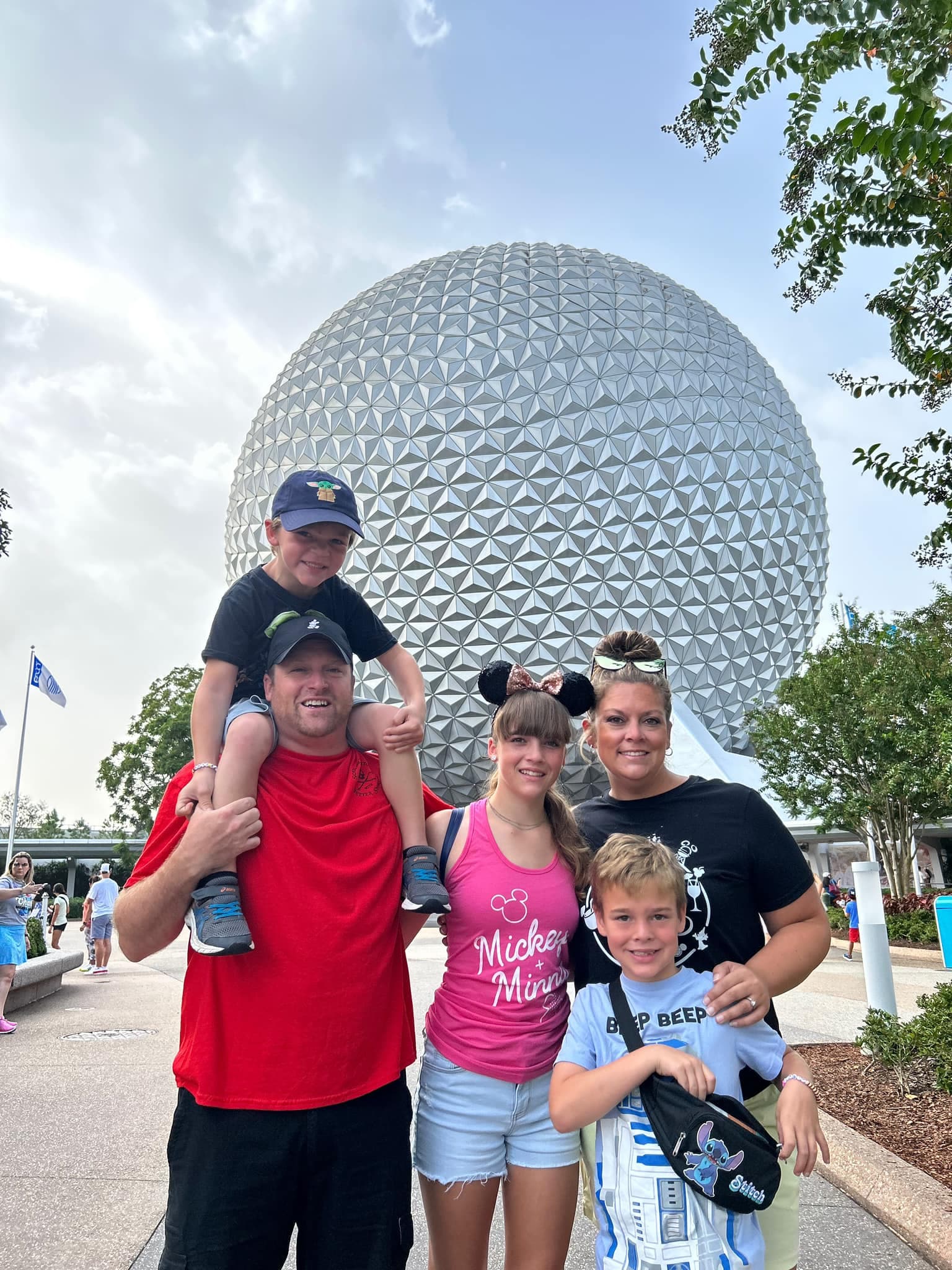 Travel advisor Michael with family standing in front of the large Epcot sphere