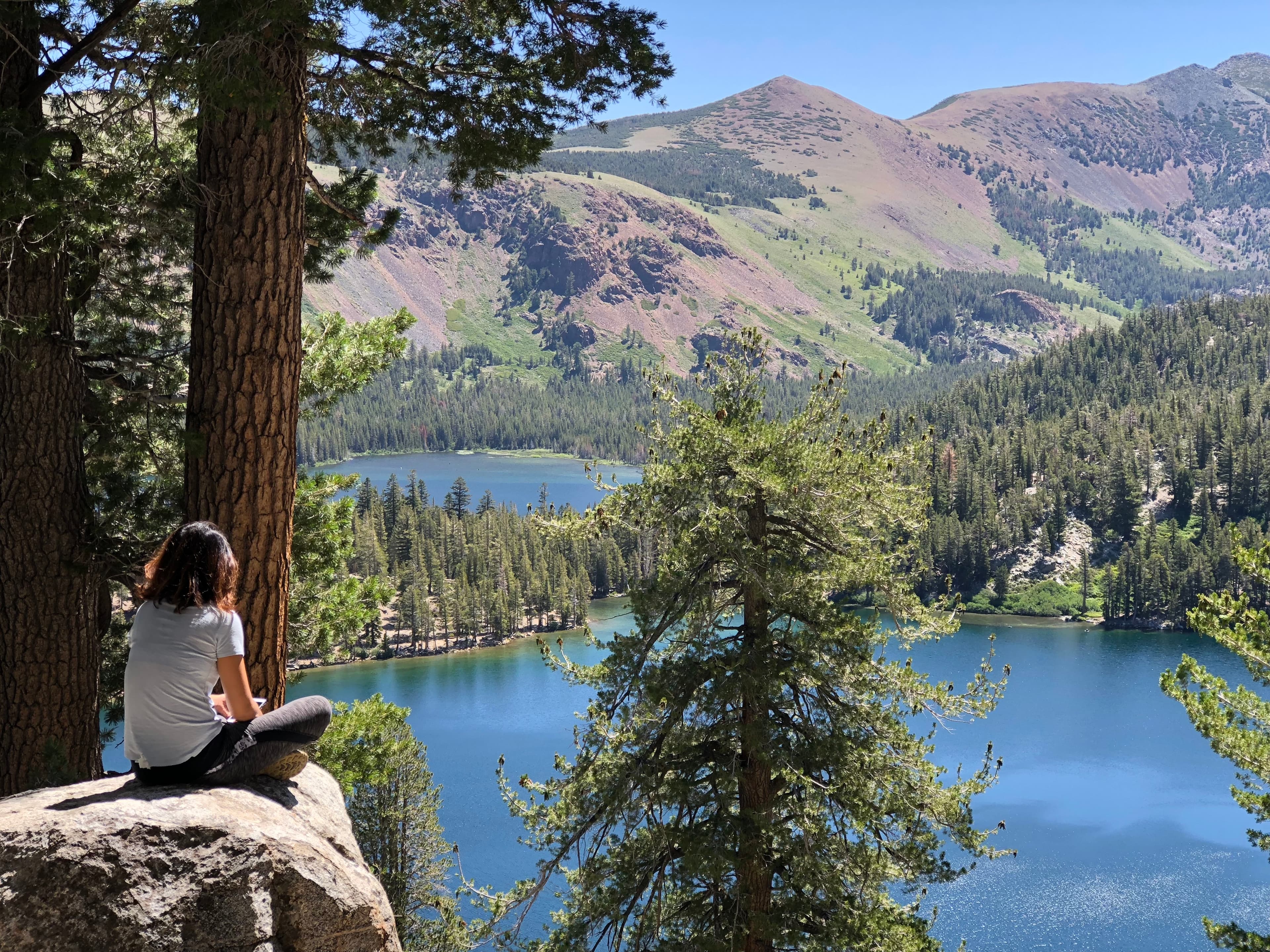 Travel advisor Carol sitting on a rock looking at the serene views of Mammoth Lakes