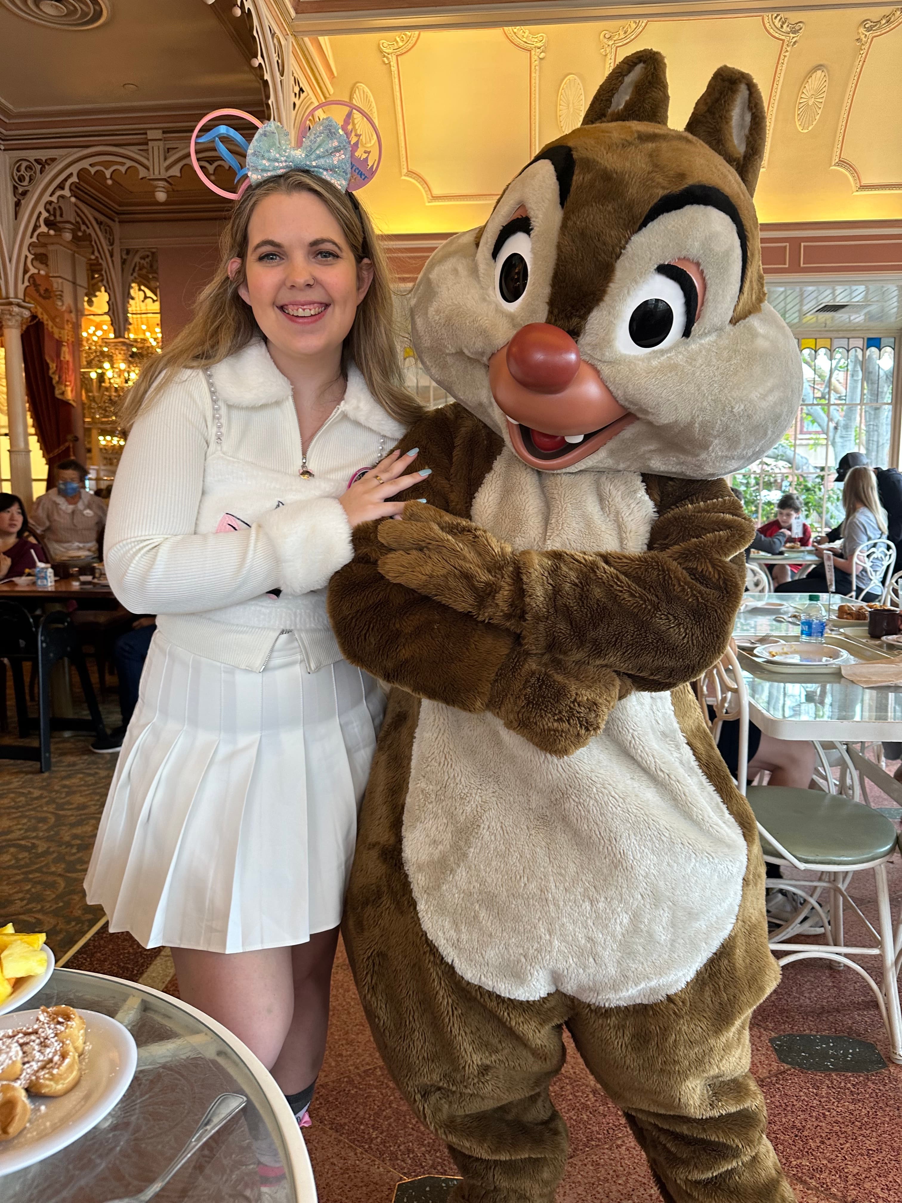 Posing for a photo with a person dressed as Disney character