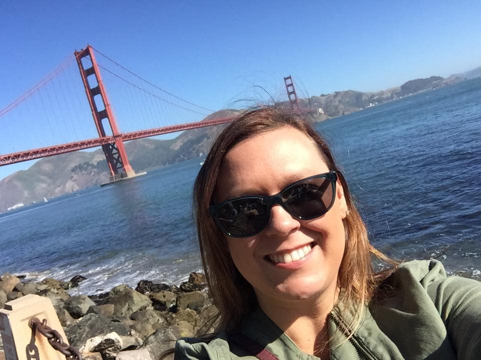 Posing for a photo by the Golden Gate Bridge