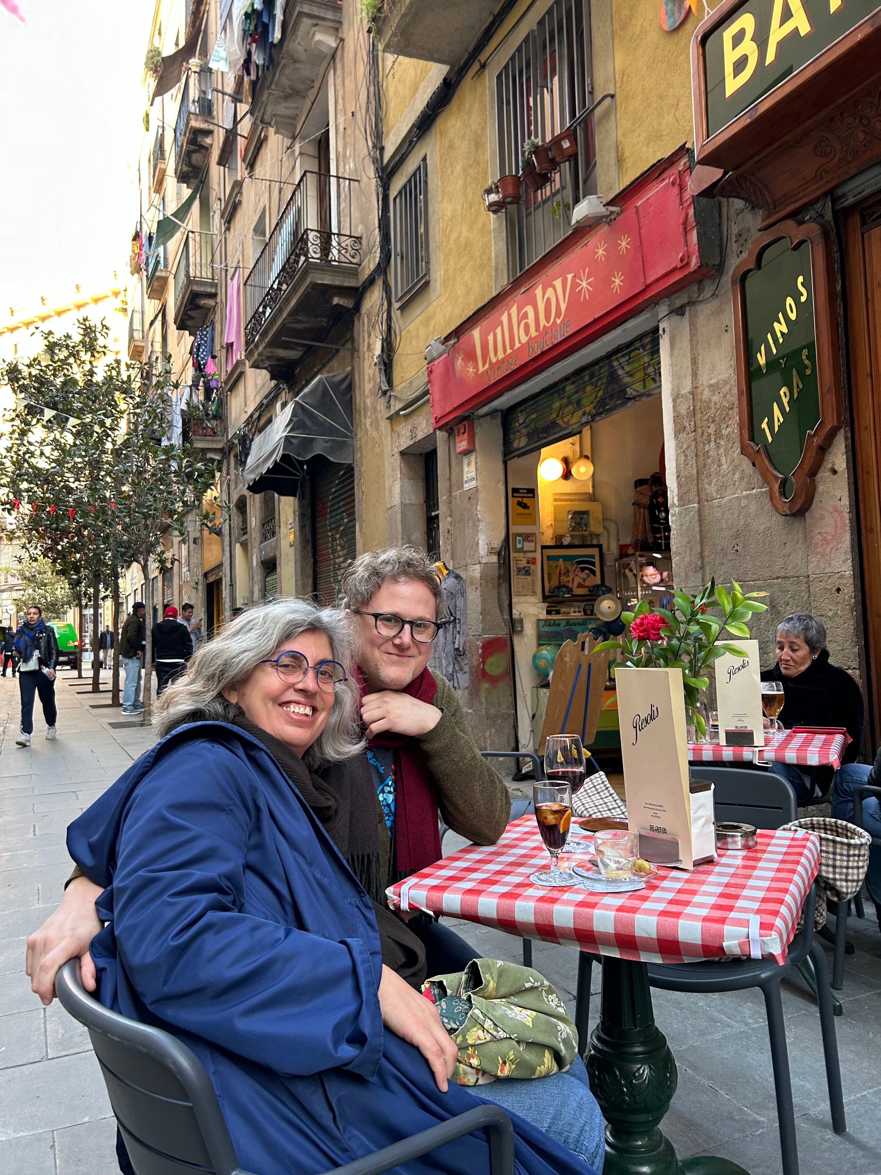 Travel advisor Joshua dining with companion at outdoor restaurant with red and white tablecloth