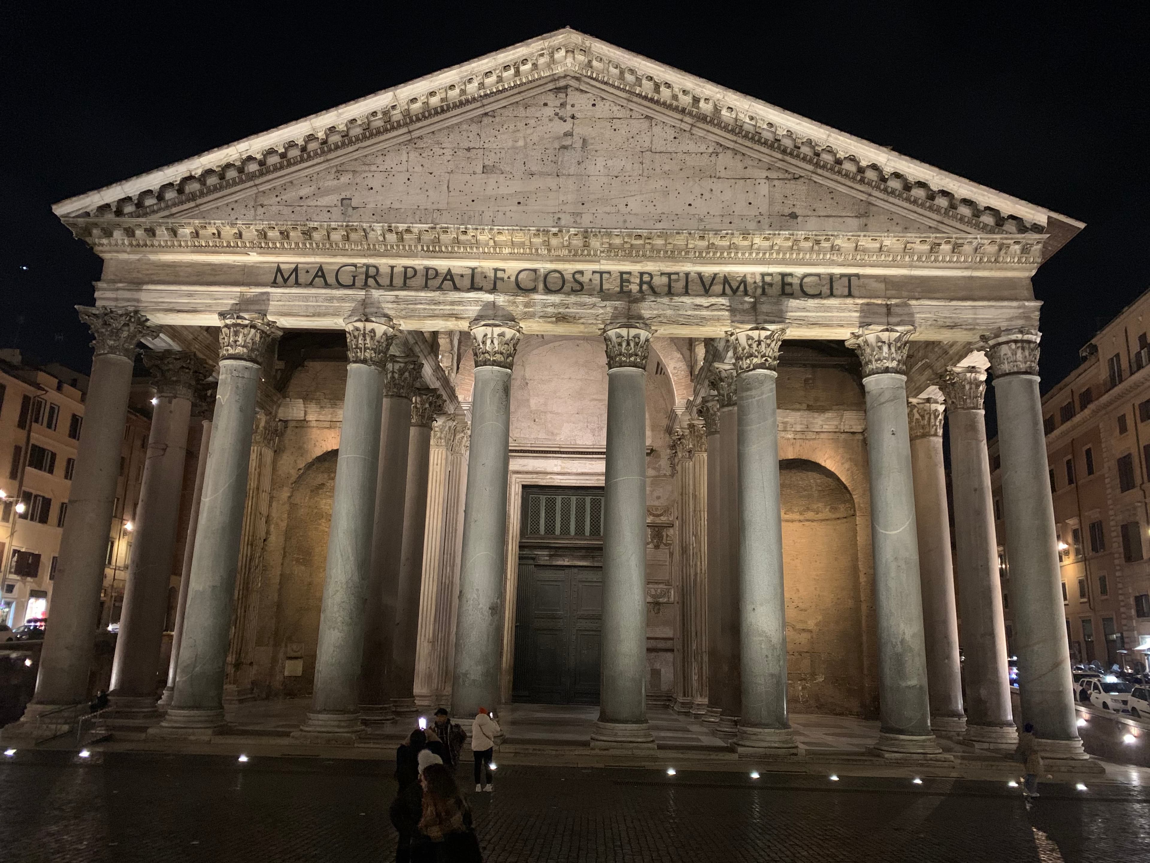 View of illuminated ancient building with pillars at night