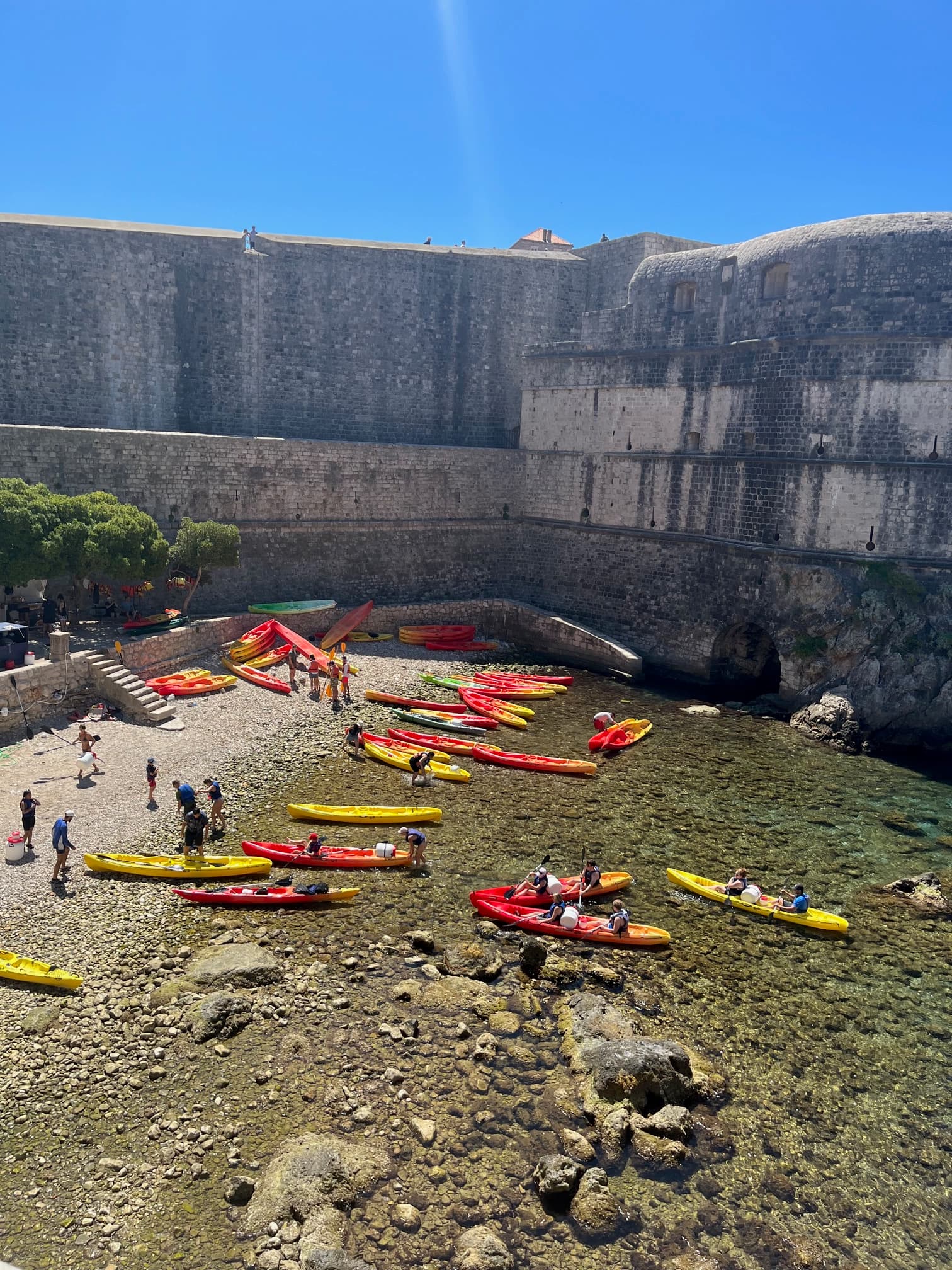 View of people in red and yellow canoes