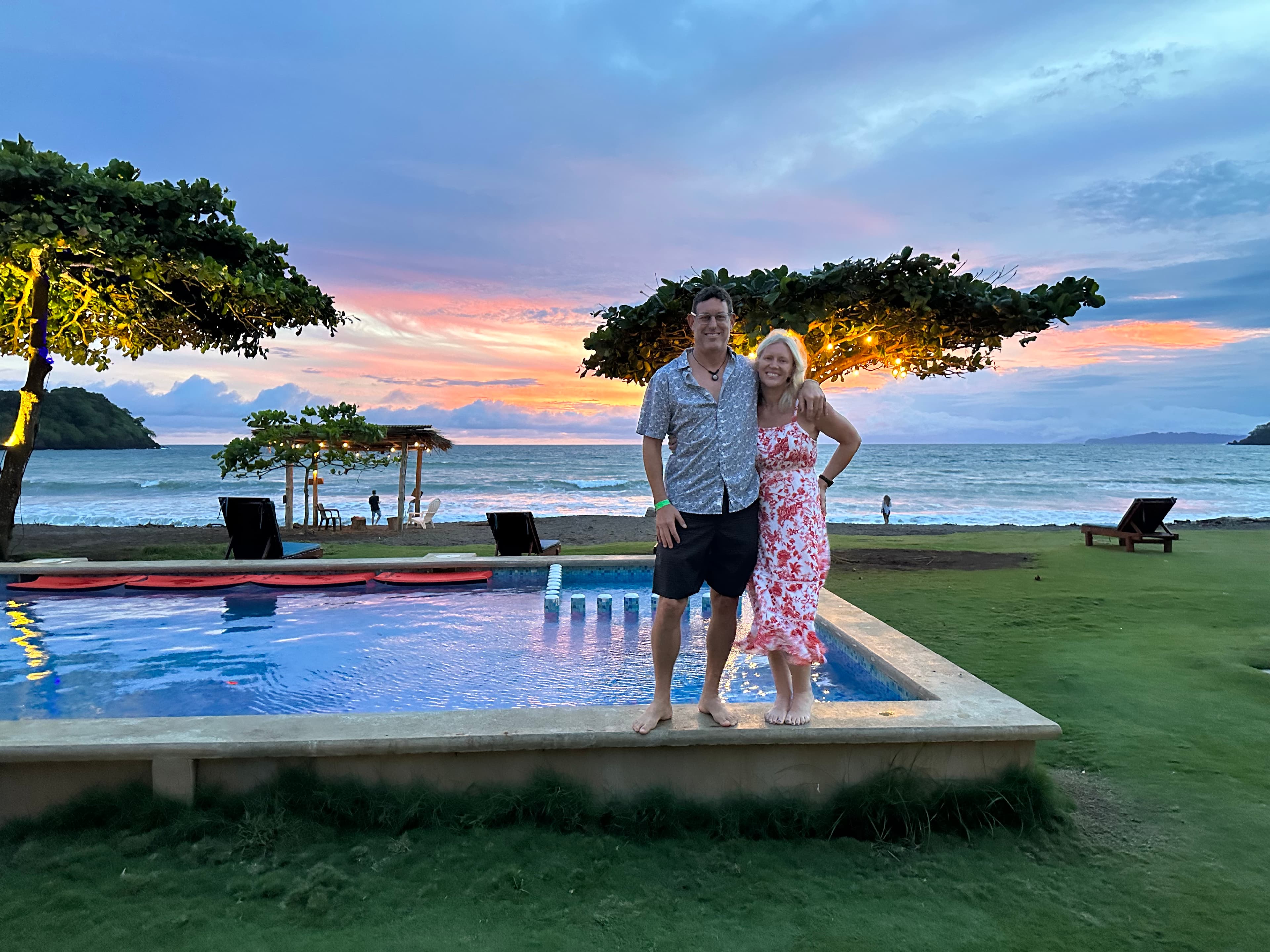 Picture of Jenny with spouse standing along the pool