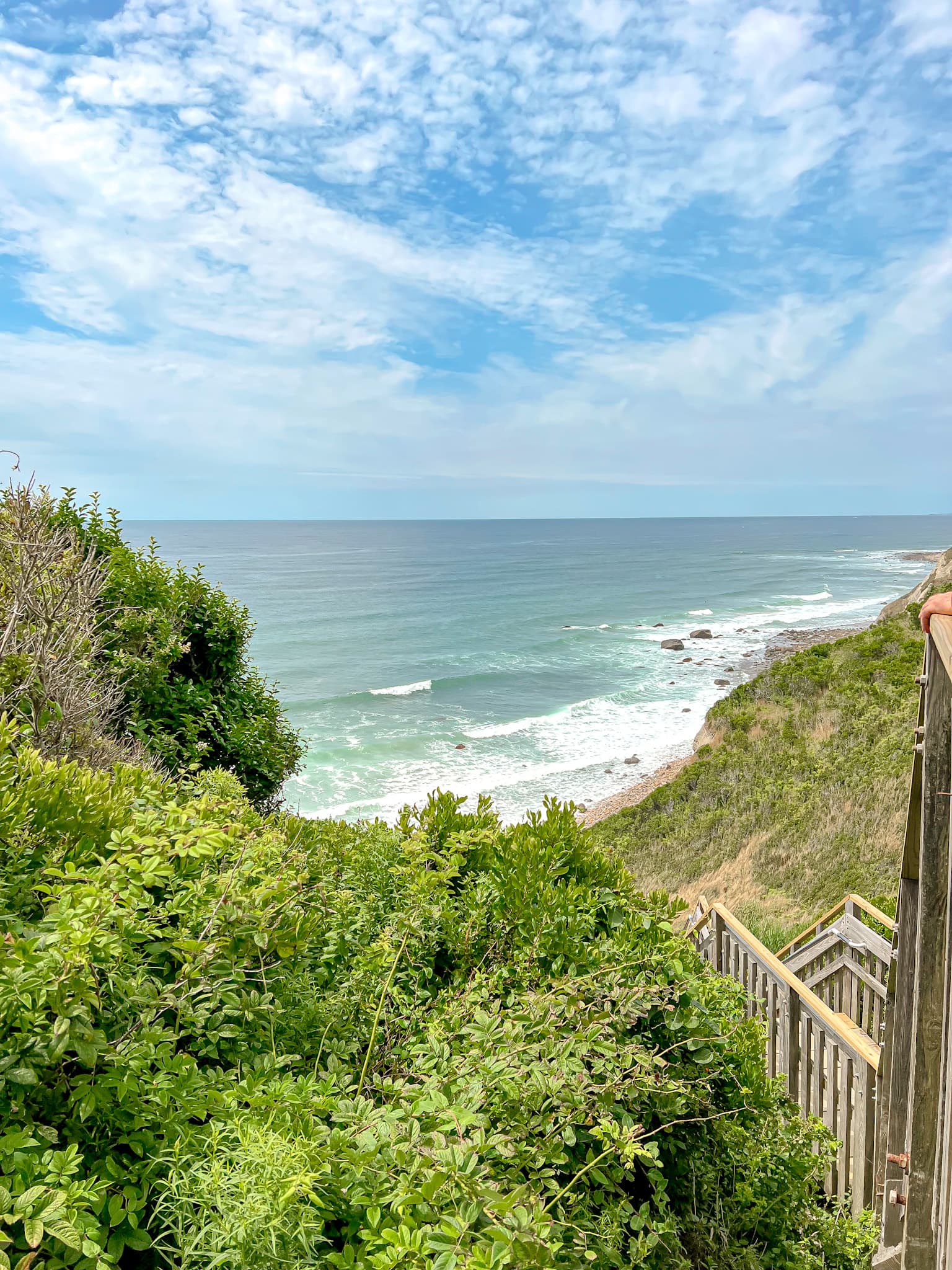 Beautiful view of stairs leading down to a beach