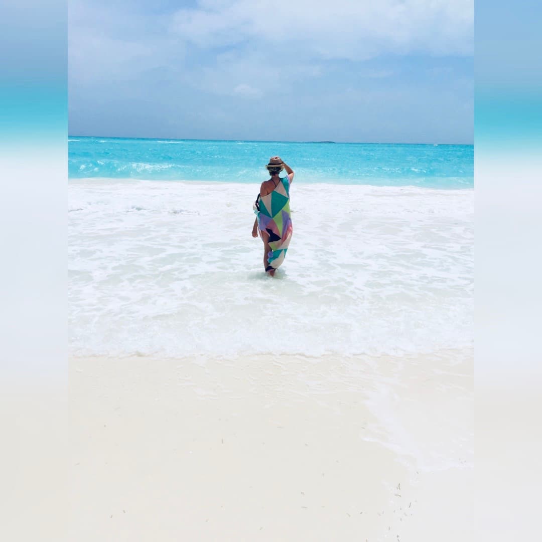 Travel advisor Jennifer standing on a beautiful beach