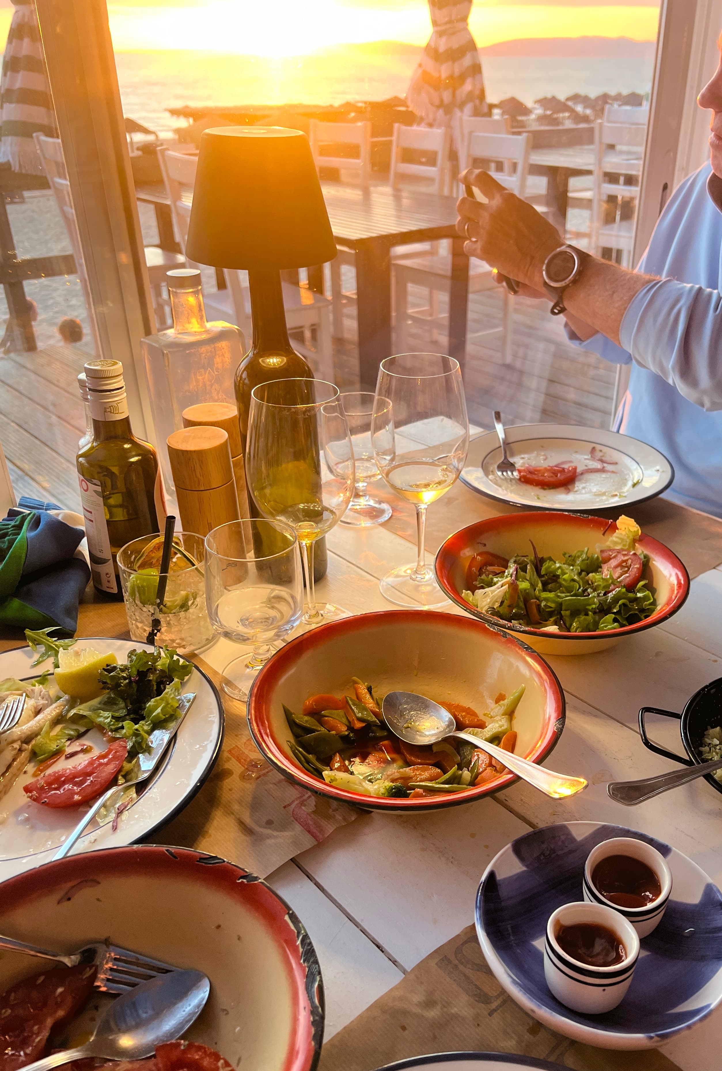 A view of food on a table at a restaurant at sunset