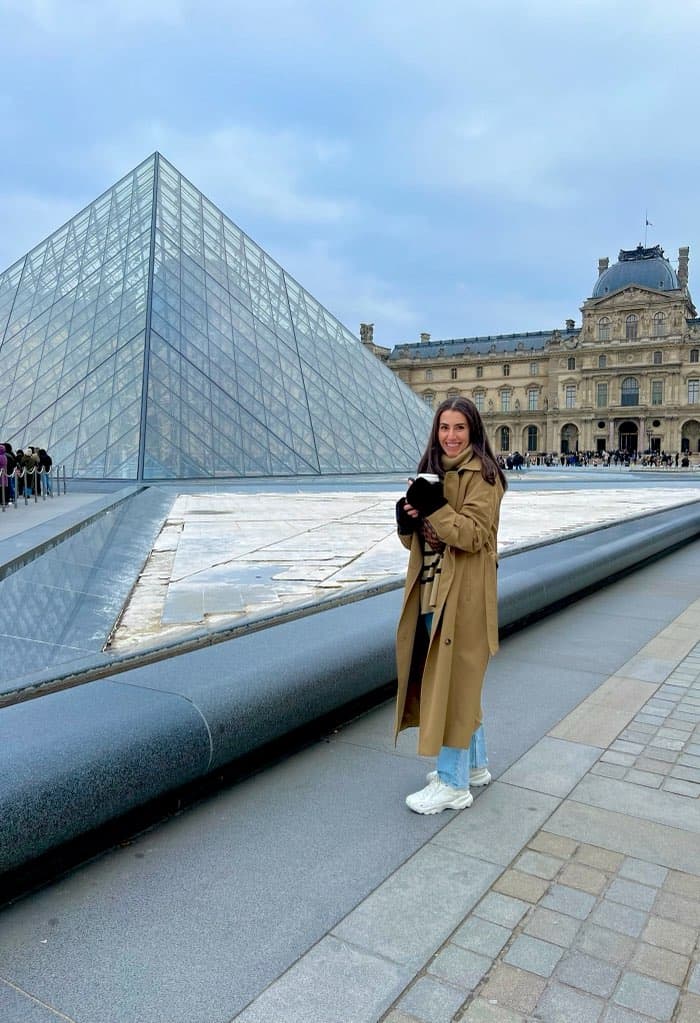 Alex posing in front of the Louvre Museum in Paris.