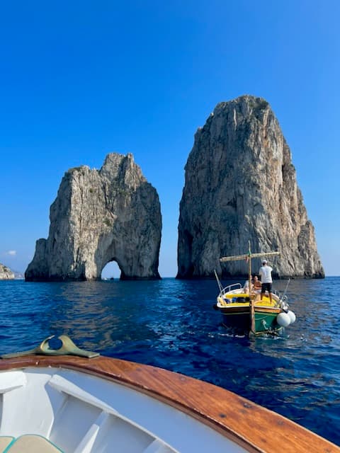 View from the boat of ocean and two large rock structures