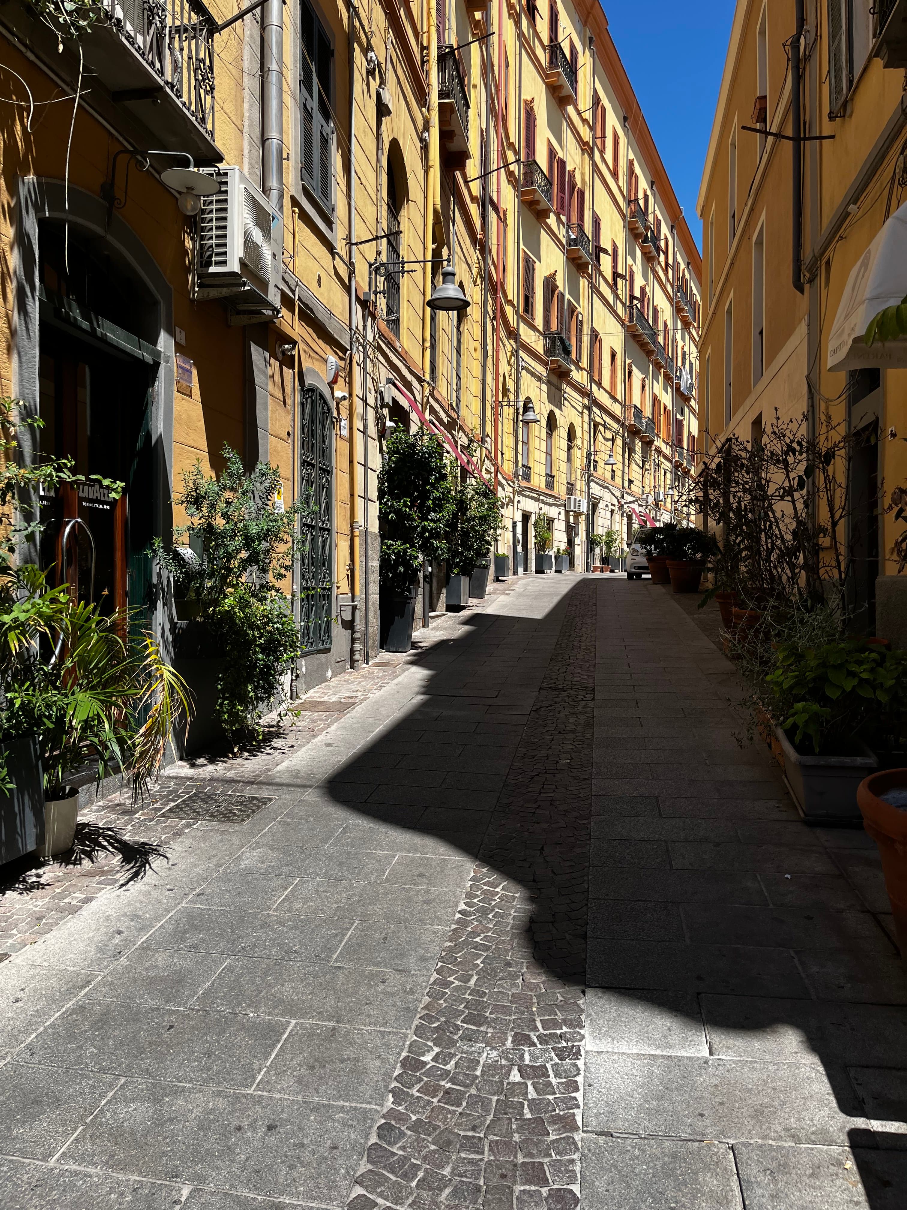 View of a narrow street with yellow buildings