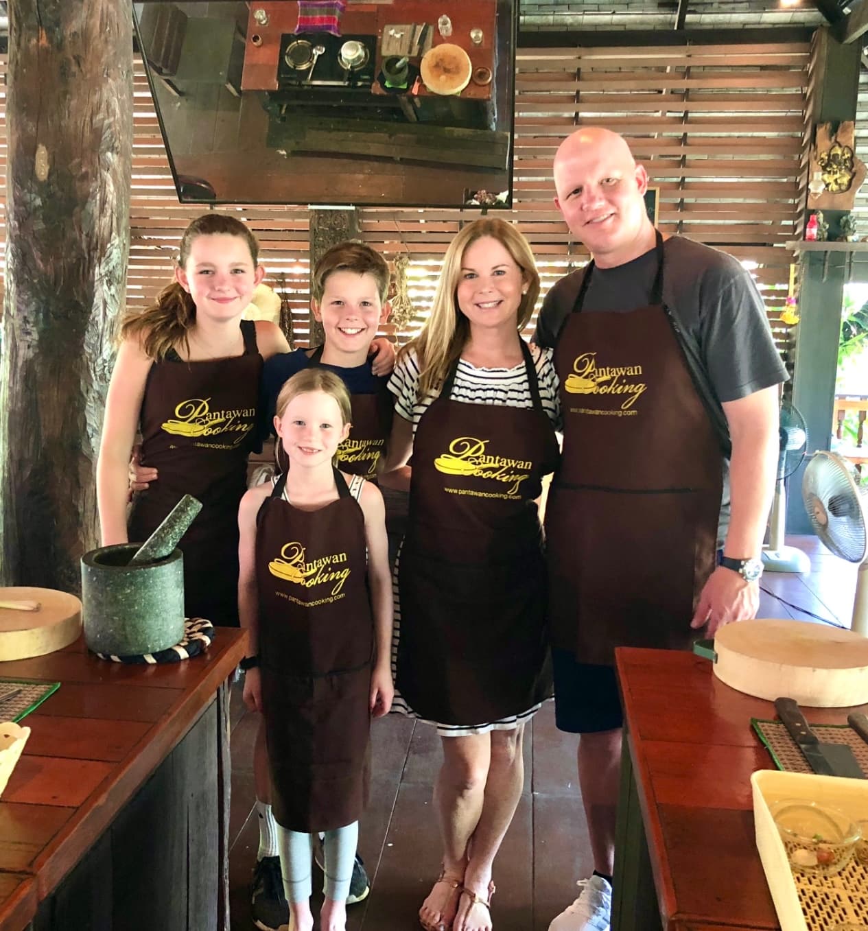 Ashley posing with her family at a cooking class.