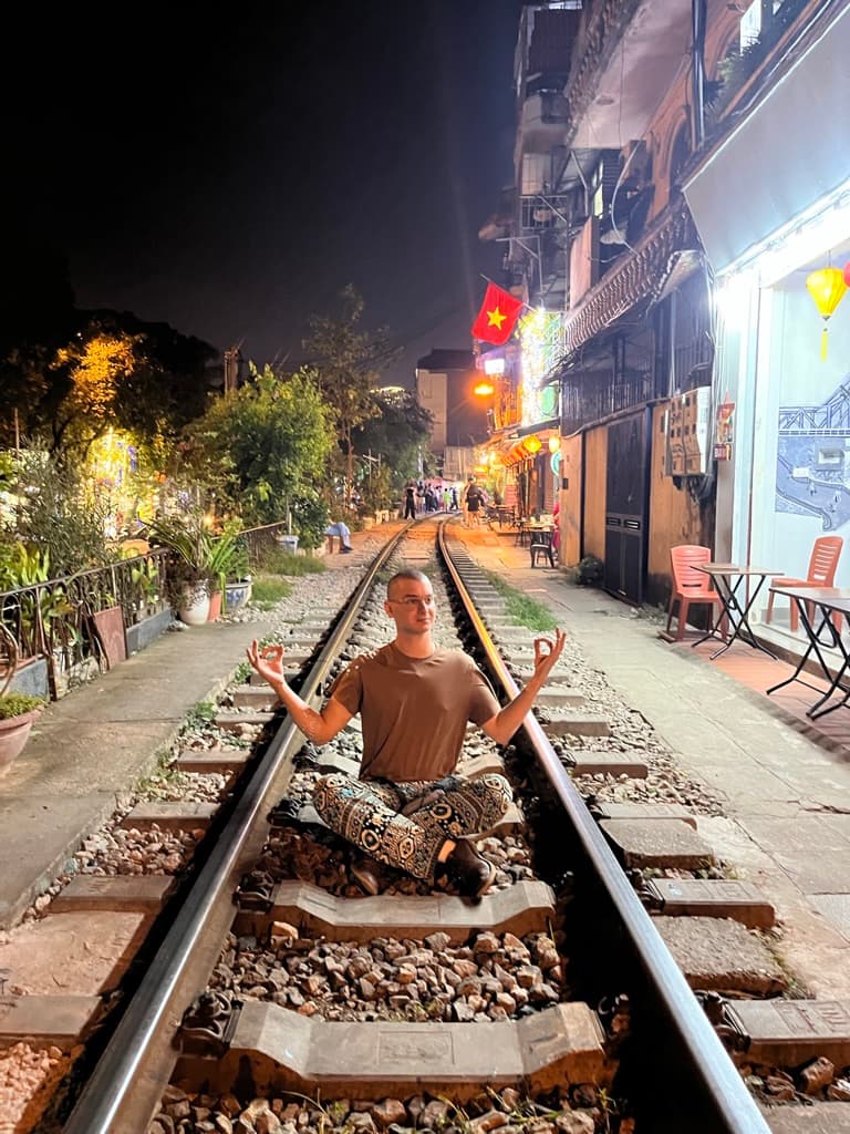 Picture of Giuseppe sitting on a train track